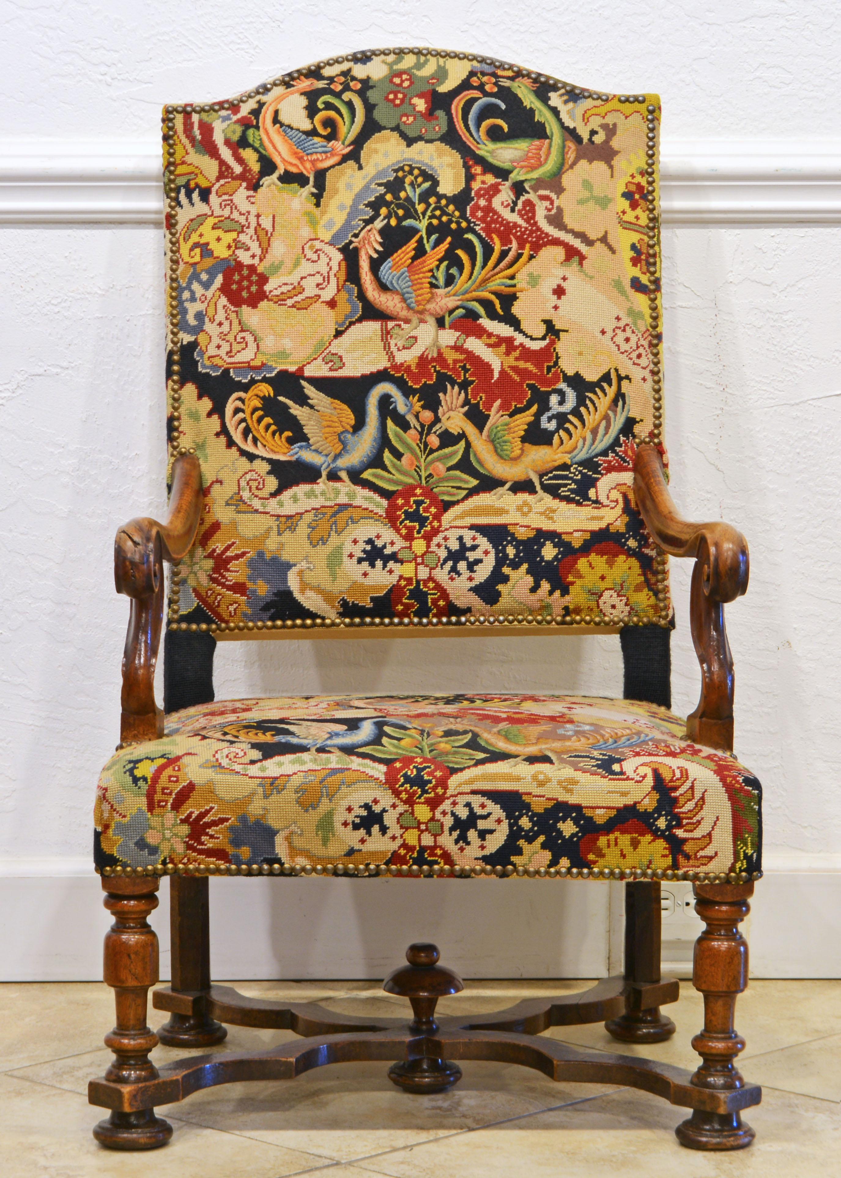 This magnificent French Provincial arm chair in the baroque style features a tall arched backrest and down swept carved armrests on serpentine shape supports rising from the seat frame. The baluster turned front legs and the straight back leg are