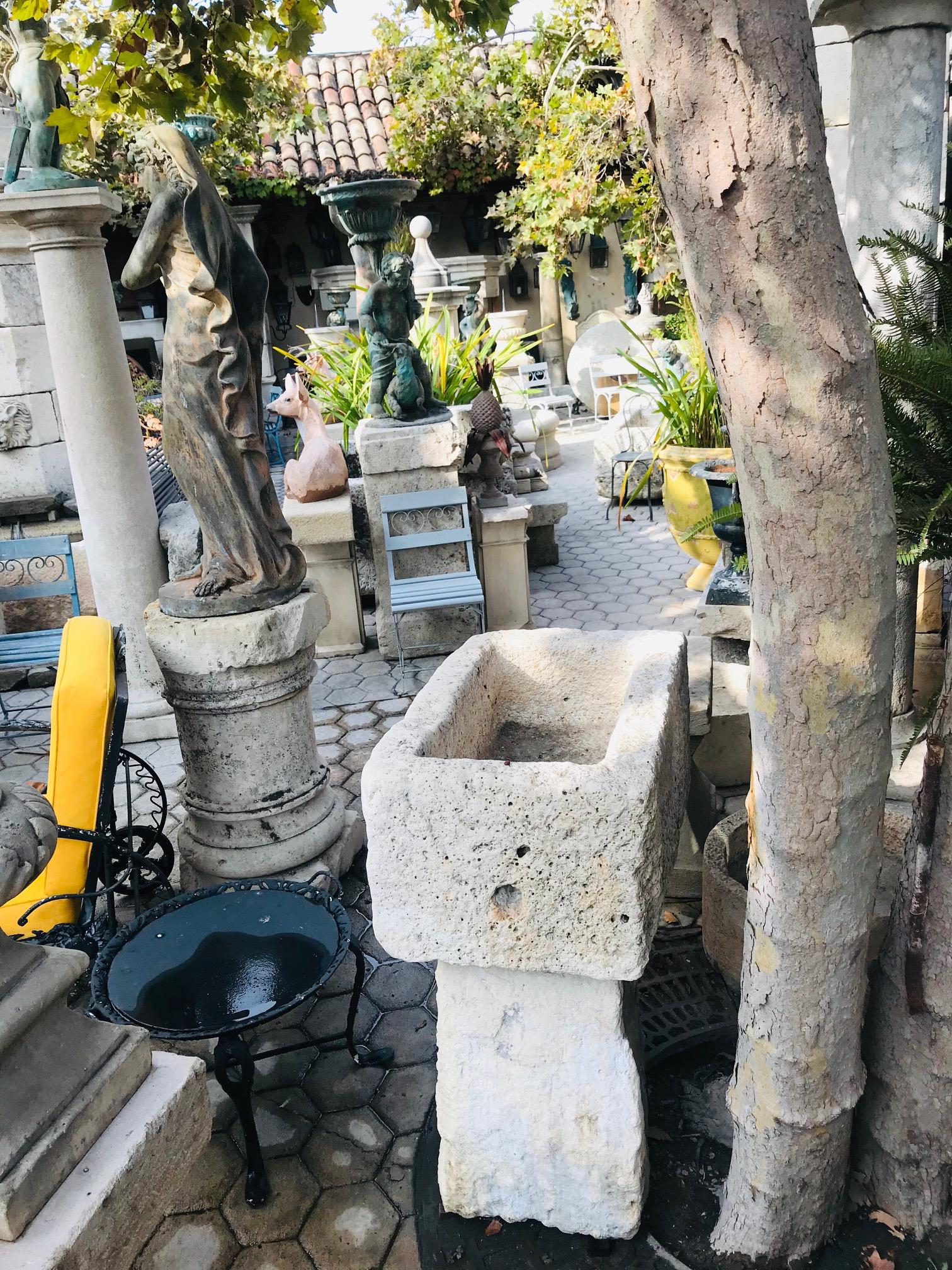 A beautiful carved stone birdbath made of two elements. An 18th century hand carved limestone Stone container planter from France, sitting on a carved Stone pedestal base with simple lines . We can sell the basin without the base. Antiques Los