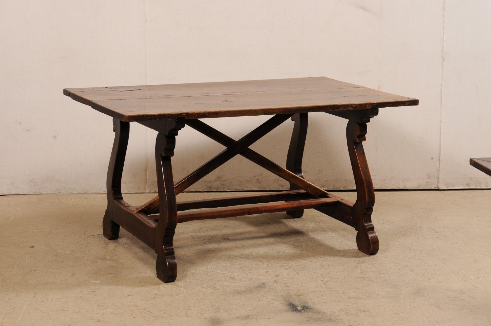 An Italian carved walnut wood table with lyre legs from the 18th century. This antique table from Italy features a rectangular-shaped top which is raised upon a pair of sinuously carved lyre inspired trestle-style legs. The legs are braced beneath