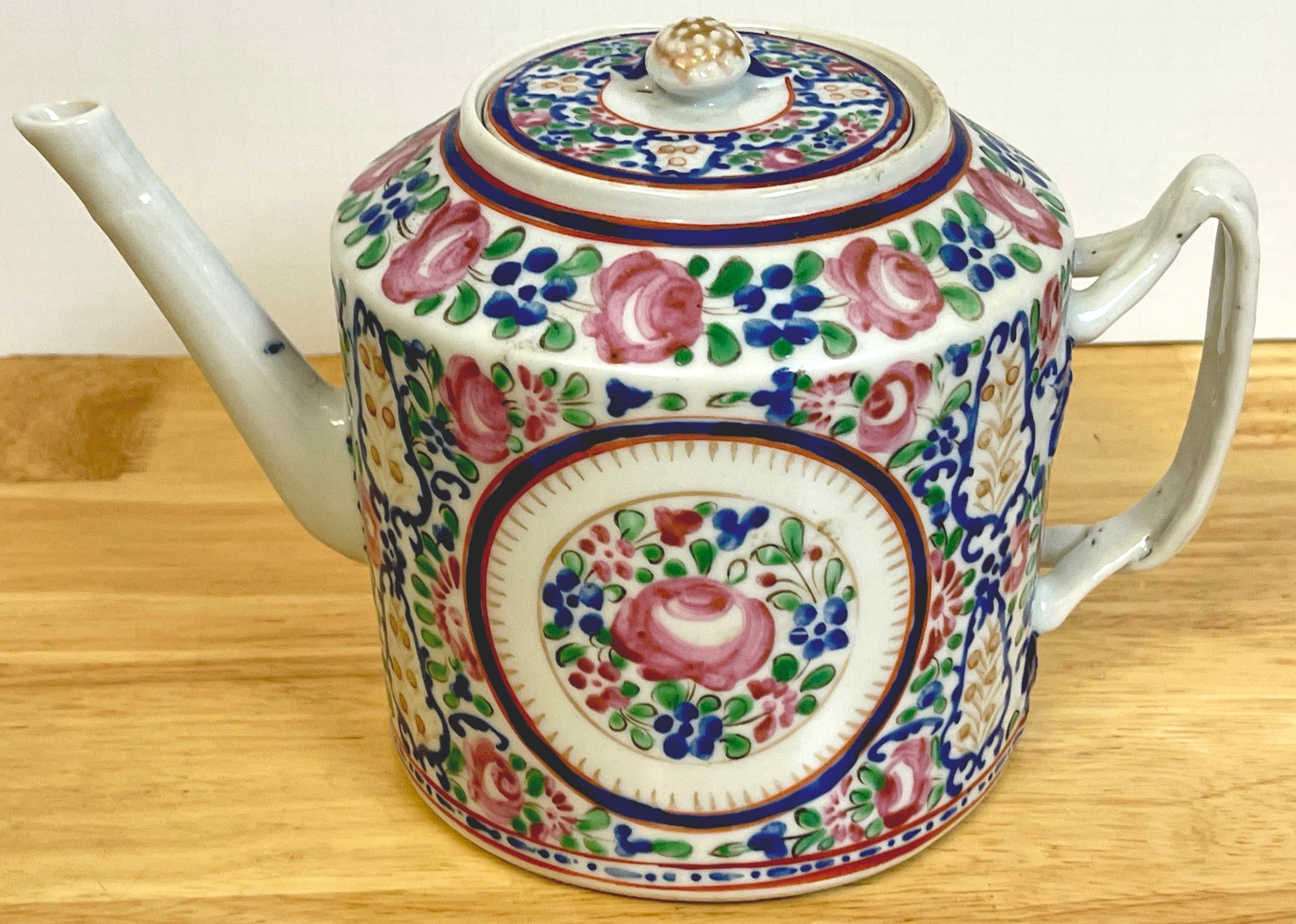 18th C Chinese Export Famille rose tea pot, in the French taste, of typical form the drum shape with twisted strap handles, and straight angled spout. The body with 'Sevres' style famille rose continuous decoration.