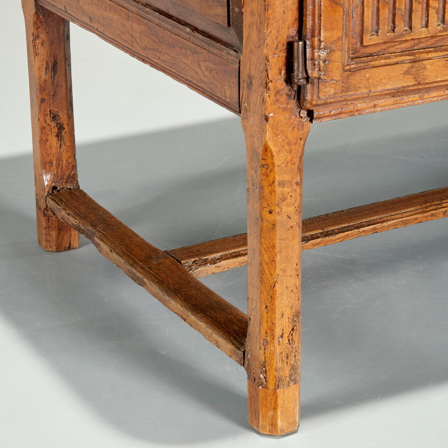 18th c., possibly Spanish, solid oak table, wrought iron hardware, the rectangular three board plank top over two hinged panel doors opening to storage, raised on octagonal legs joined by h-stretcher. With a beautiful buttery patina and sturdy