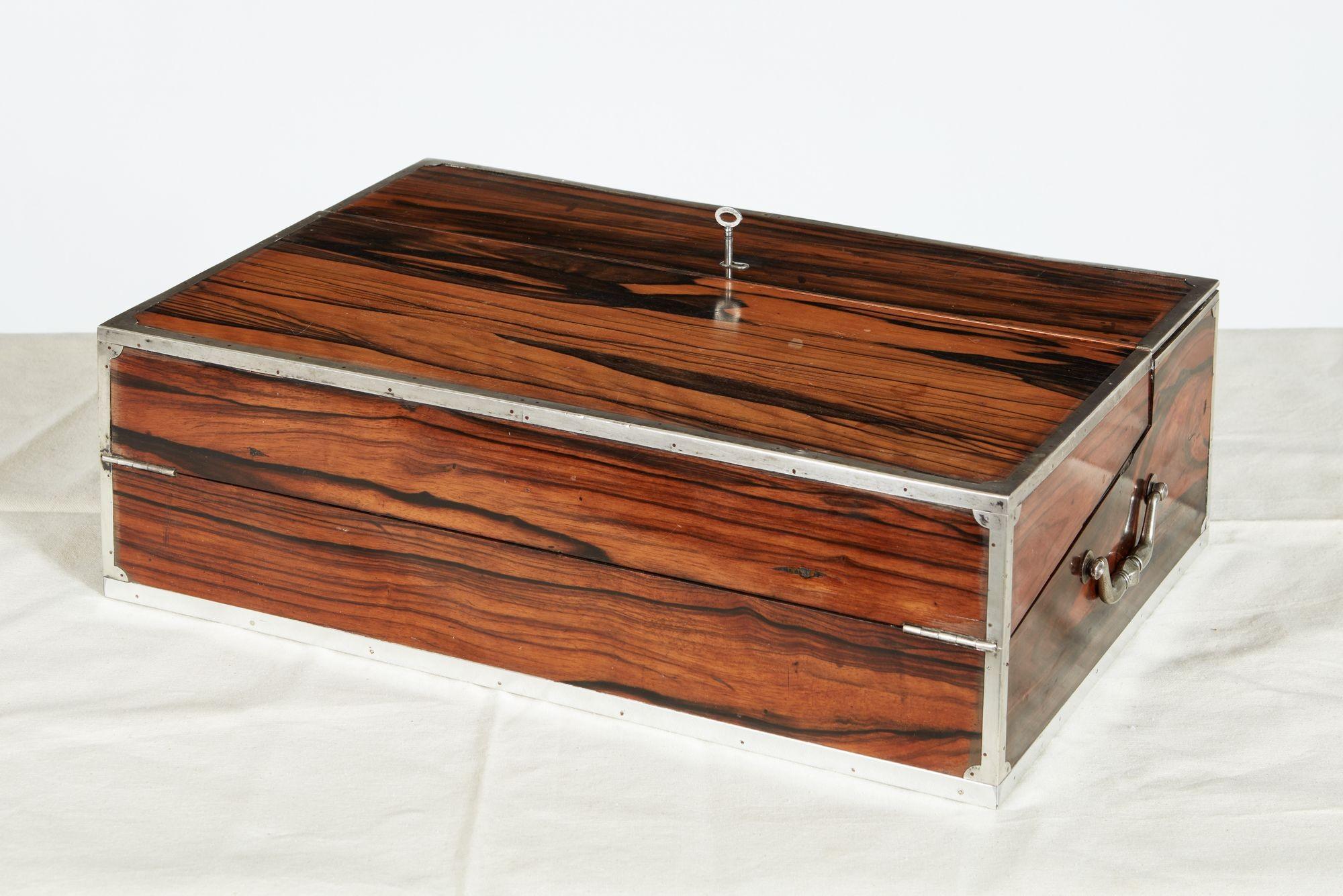 Very fine 18th century Indian Macassar Ebony traveling writing box with Tutenag metal hardware, the vividly grained case with rare alloy trim, the rectangular form opening to make a sloped writing surface, each felt lined surfaces lifting to reveal