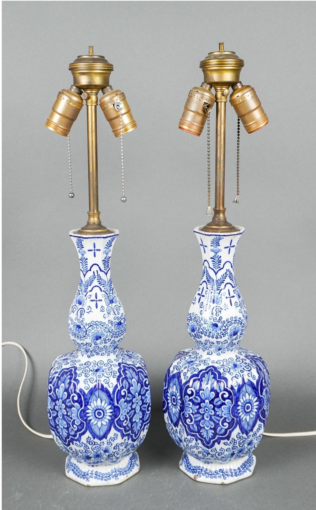 An extremely rare, superb large pair of antique 18th-century Dutch Delft faience knobble vases mounted as lamps, circa 1770s by Van Duijn.
A classic blue and white color palette adorns this abundantly flowers decorated lamp mounted vases. These