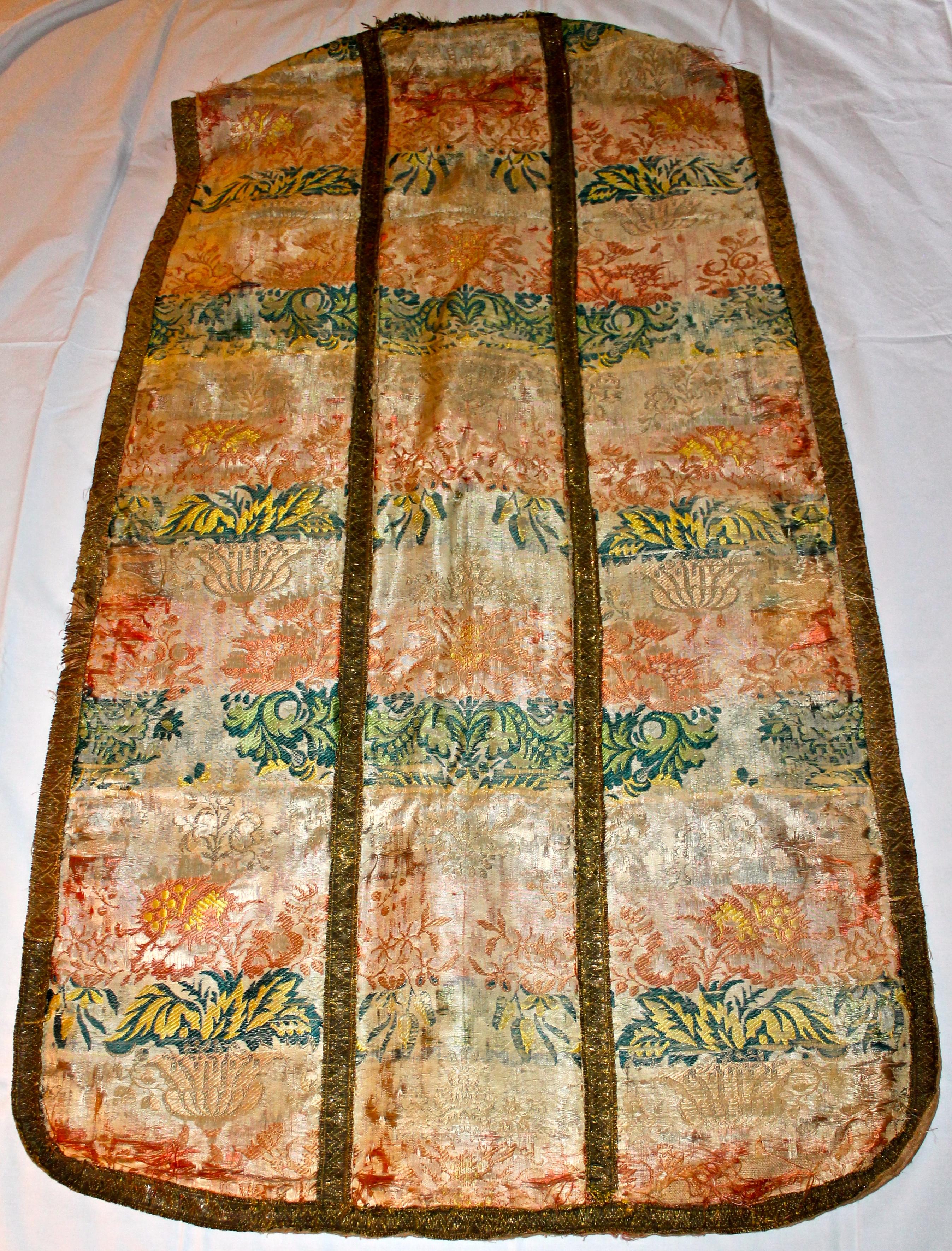 Silk embroidered antique vestment. Lined in linen. Old repairs- basically a covering of some of the more thinned areas on the front.