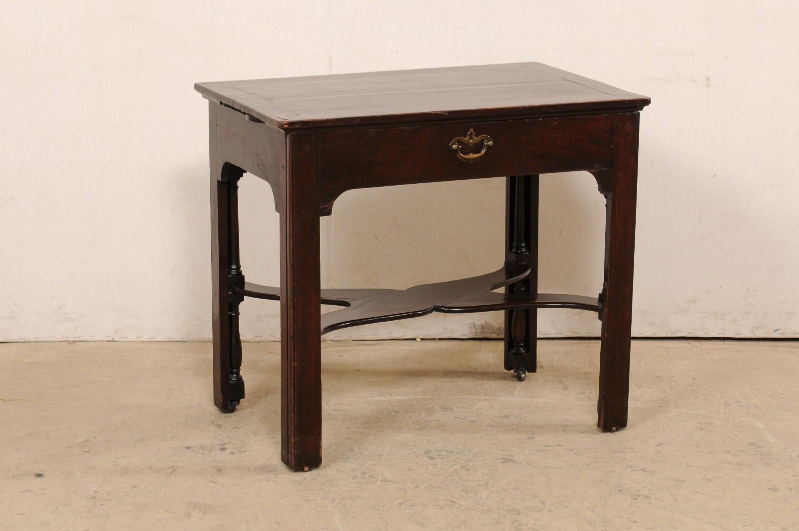 An English expandable architect's table with candle stands from the 18th century. This antique table from England would have originally been used as an architects work desk, complete with a pair of small shelves that pull out from either side of