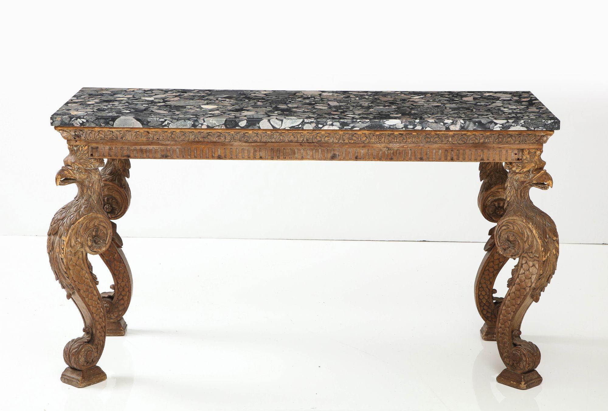 A very fine English marble top console table in the manner of William Kent, having features found in documented examples of Kent's work at Chiswick House and Holkham Hall. Reeded and acanthus carved apron over bold carved eagle head scrolled legs