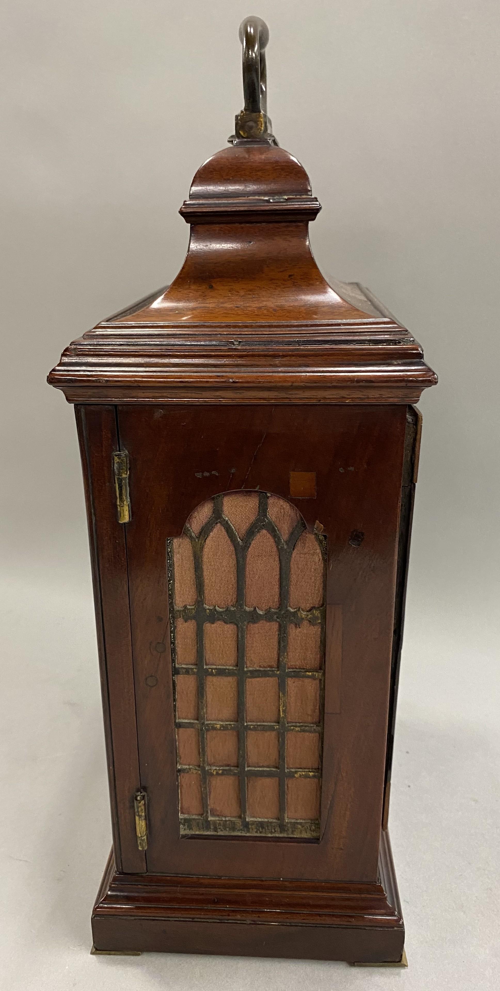 This English mahogany table or bracket clock with bail handle is circa 1765, with a  composite brass dial with recessed 4 ½” maker's boss marked Edward Foster, London.. It has a Roman numeral chapter ring with calendar ring engraved 1-31 around the