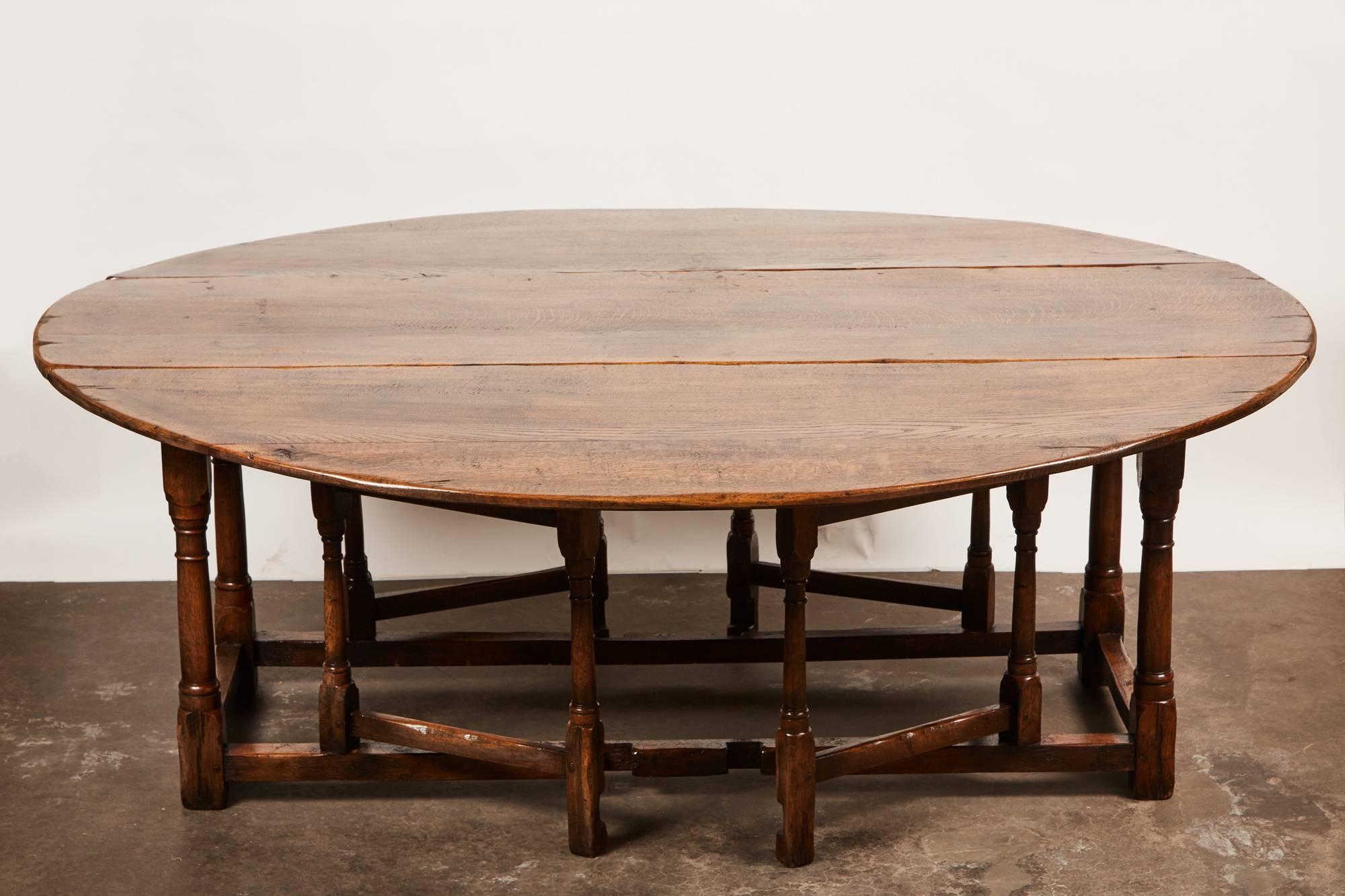 A wonderful late 18th century style English oak drop-leaf gate leg table. Made of solid English oak the top has two sides that fold up to create a large approximately  72