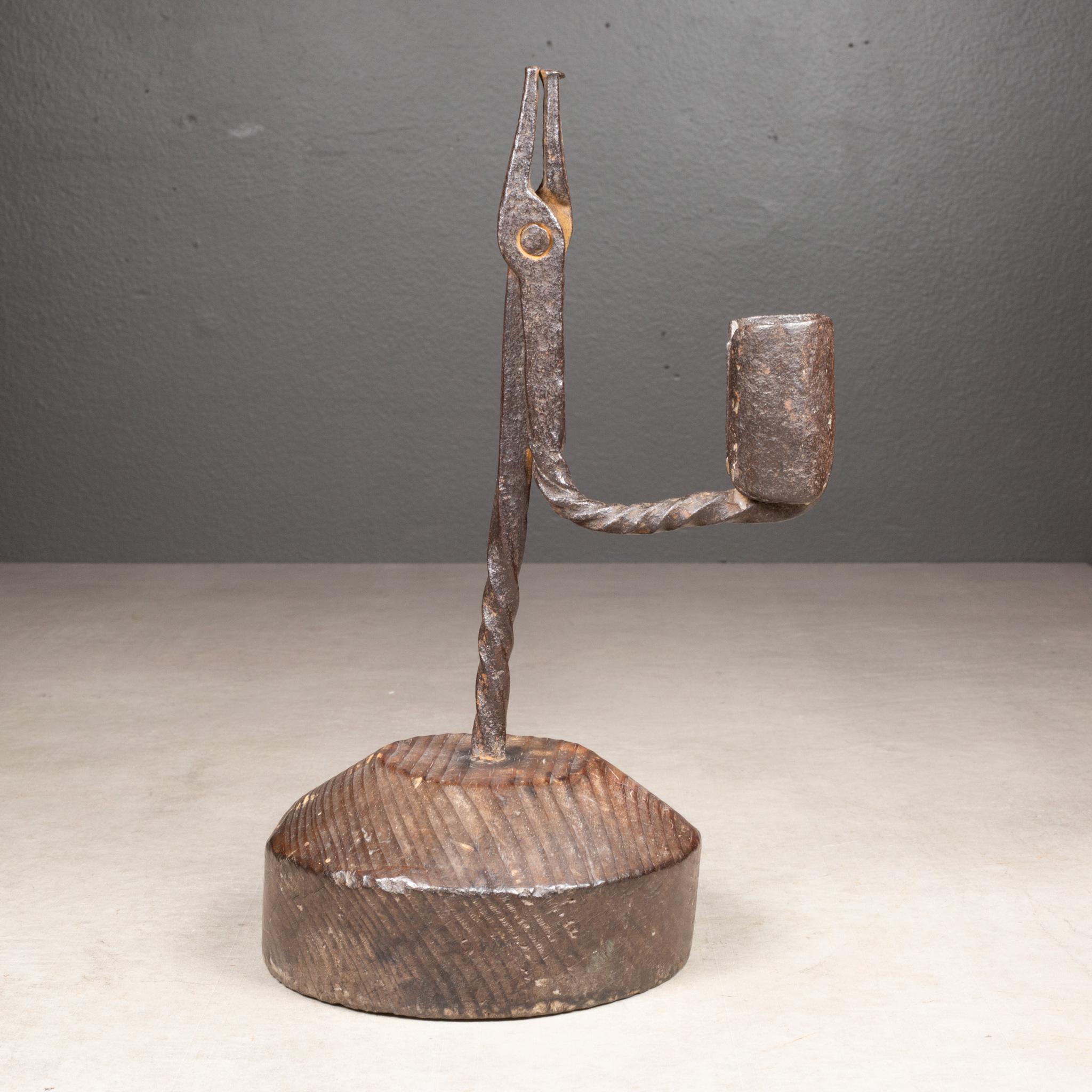 ABOUT

English Georgian rushlight, circa 1760s. Hand-wrought iron with twisted stem design on pine circular base. It features a rush nip and single candle socket.

    CREATOR Unknown. United Kingdom. 
    DATE OF MANUFACTURE c.1760. 
    MATERIALS