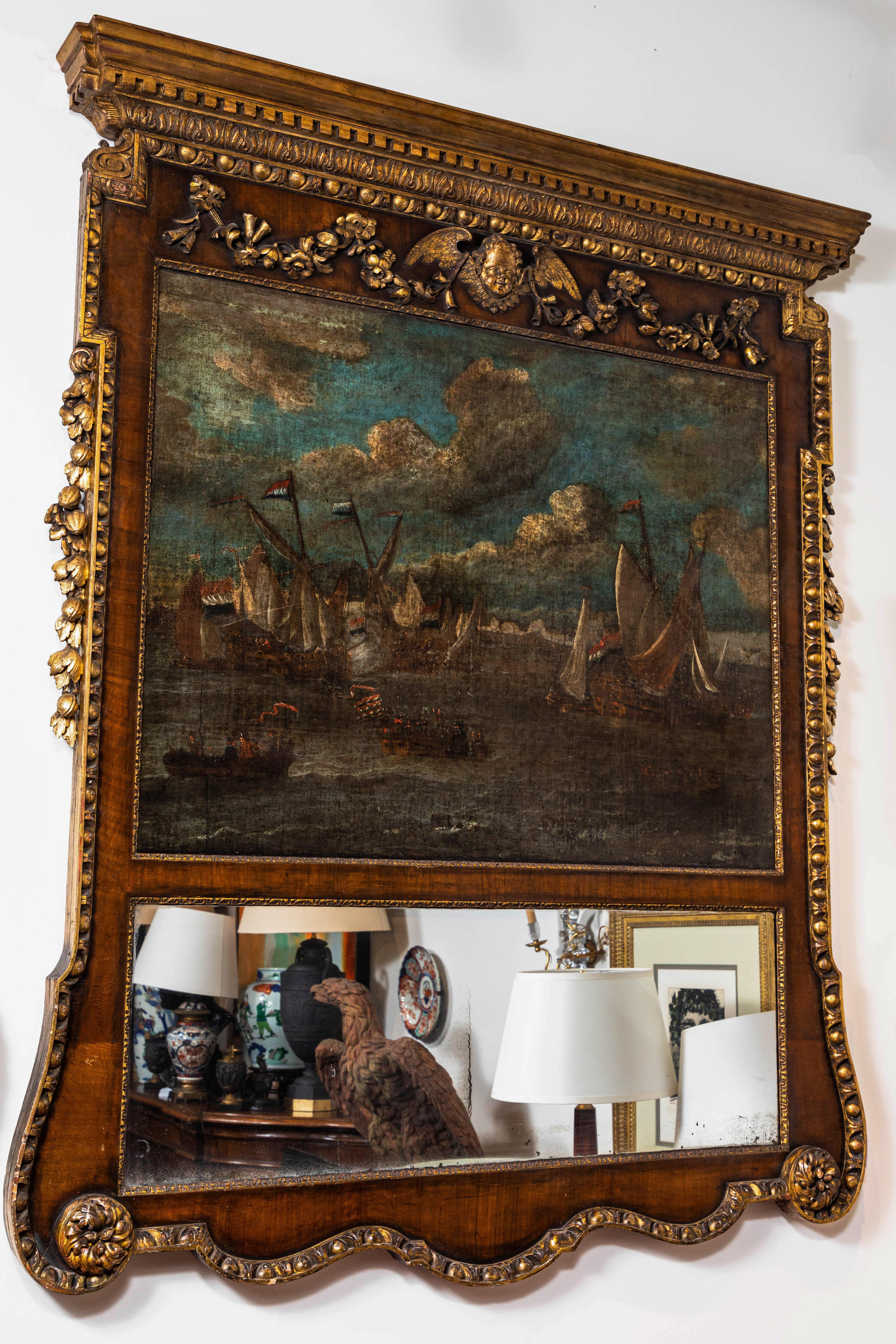 Absolutely grand, hand carved, veneered and gold gilded, late 18th century. Frame inset with both original, mercury glass, and a large oil-on-canvas naval scene featuring French ships at sea. The whole surmounted neoclassical style cornice above a