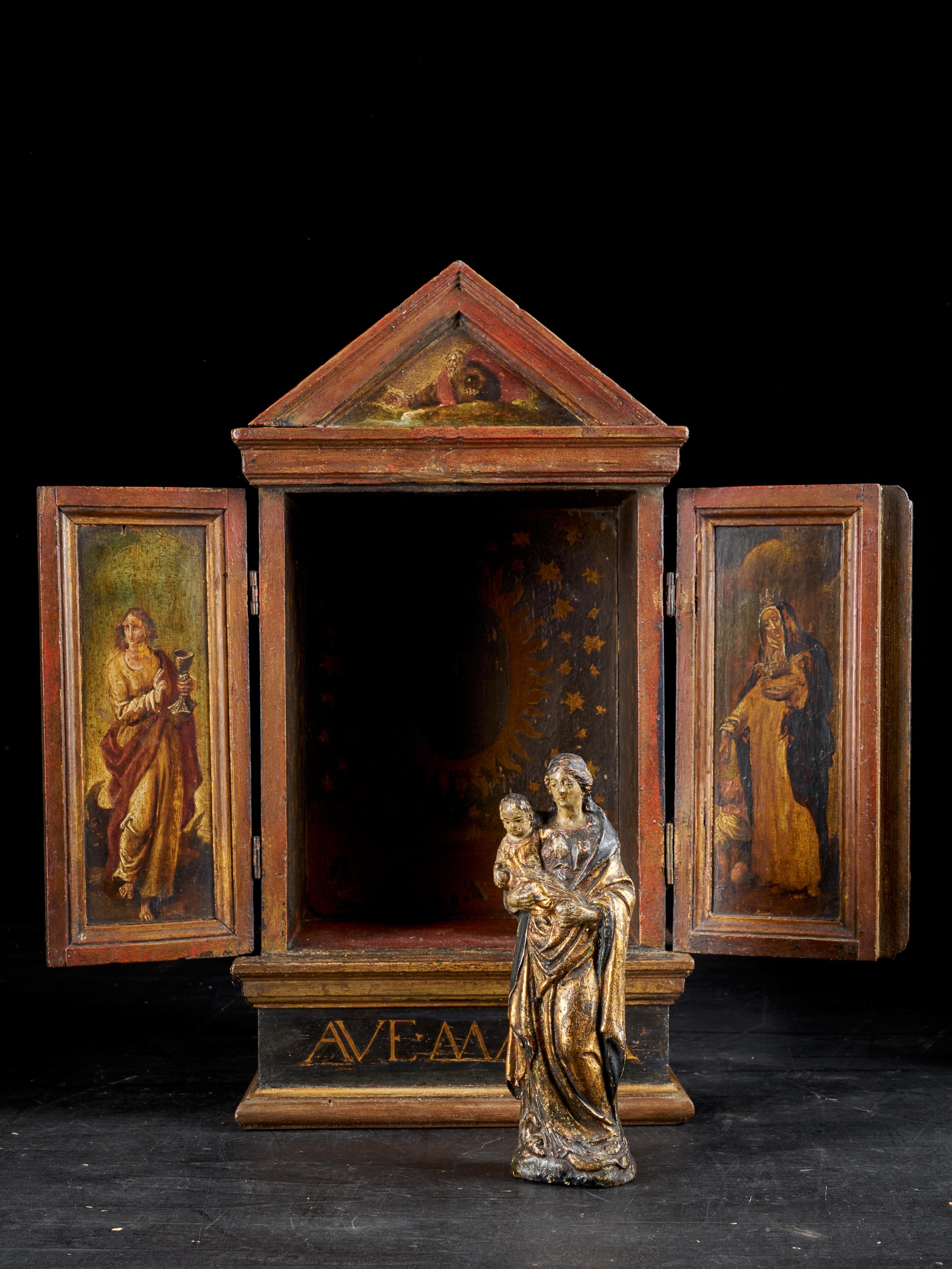 The 18th century terracotta statue is probably from the area of Mechelen. It has been placed in a very nice 19th century wooden cabinet with painted doors.