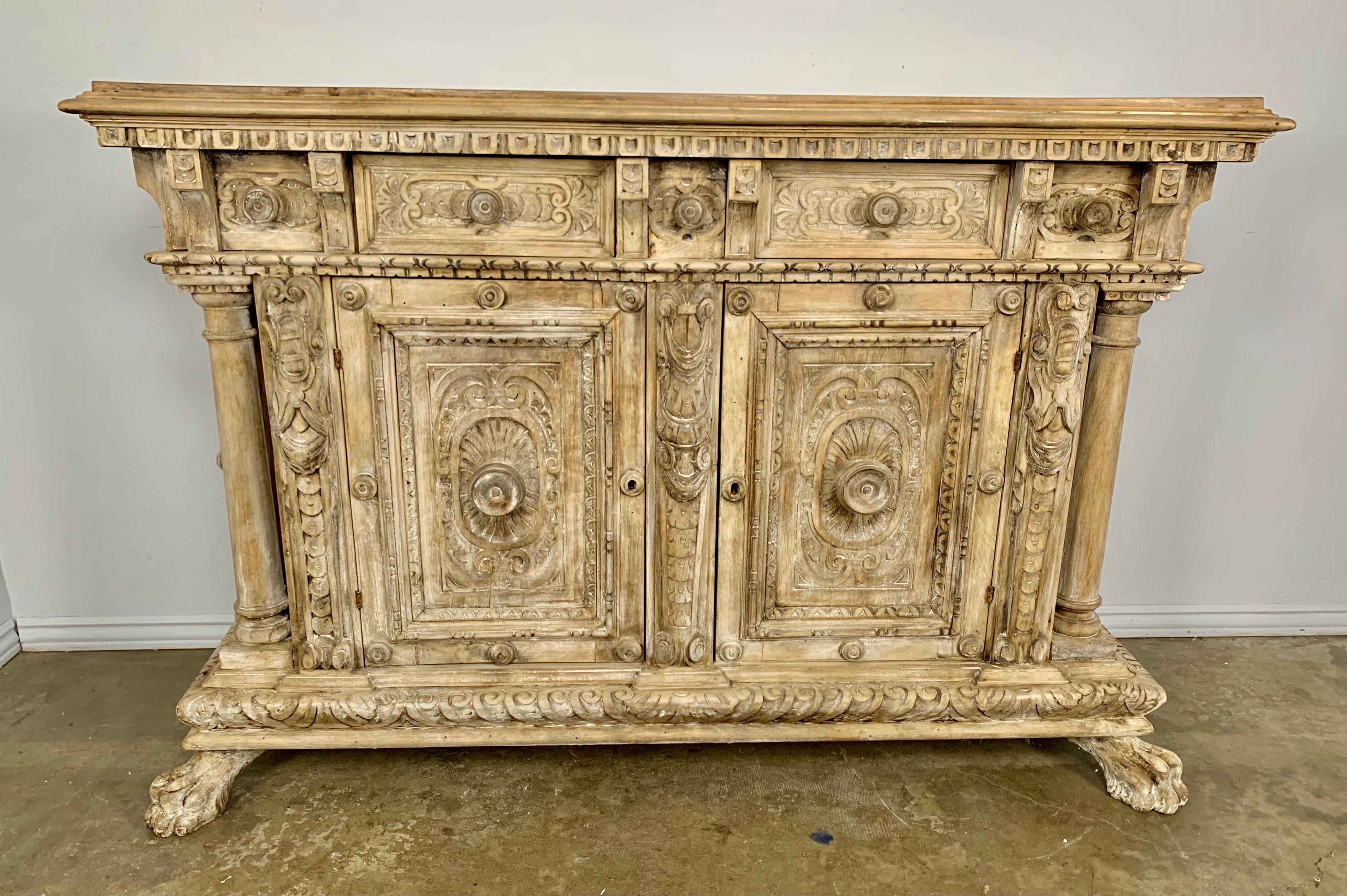 18th Century French bleached wood walnut buffet with two drawers. There are also two doors that conceal plenty of storage space. The buffet stands on four lion paw feet and is intricately carved throughout with many beautiful details.