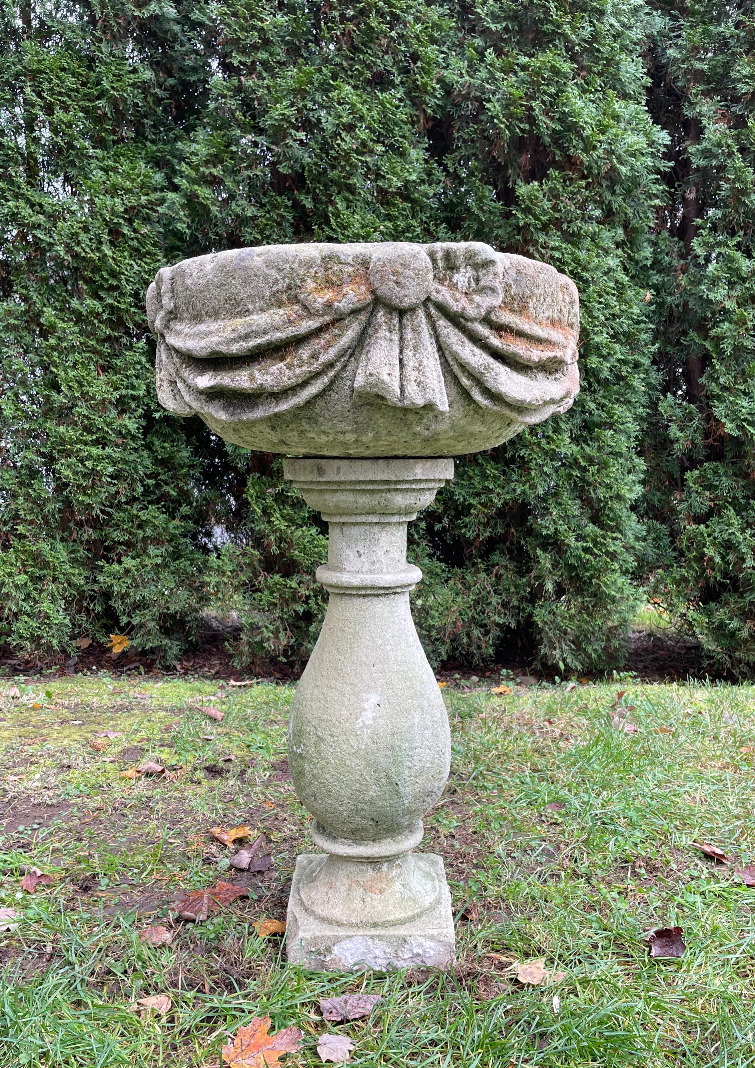 We found this stunning piece in Northwest France and although it may be a marriage, it is an excellent one. Hand-carved from limestone, the superb and deeply-carved basin has classical bow and swag decoration and the riser comprises an elegant