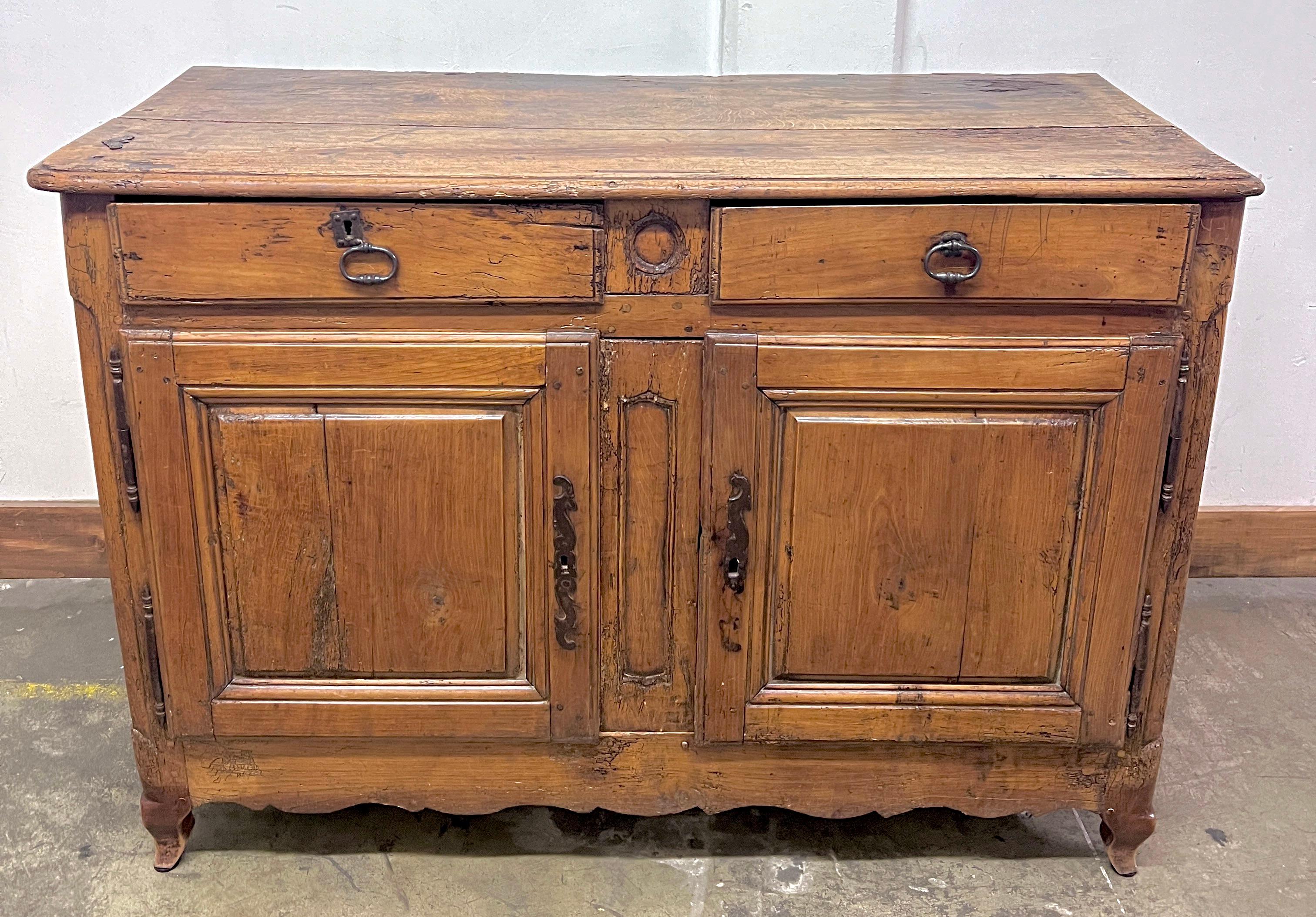 French Country 18th Century Late Regency, Early Louis xv Walnut Buffet.

A beautifully patinated solid walnut, two drawers, with storage beneath.  the piece is nearly 300 years old and in sold condition.  The buffet or cabinet would be a compliment