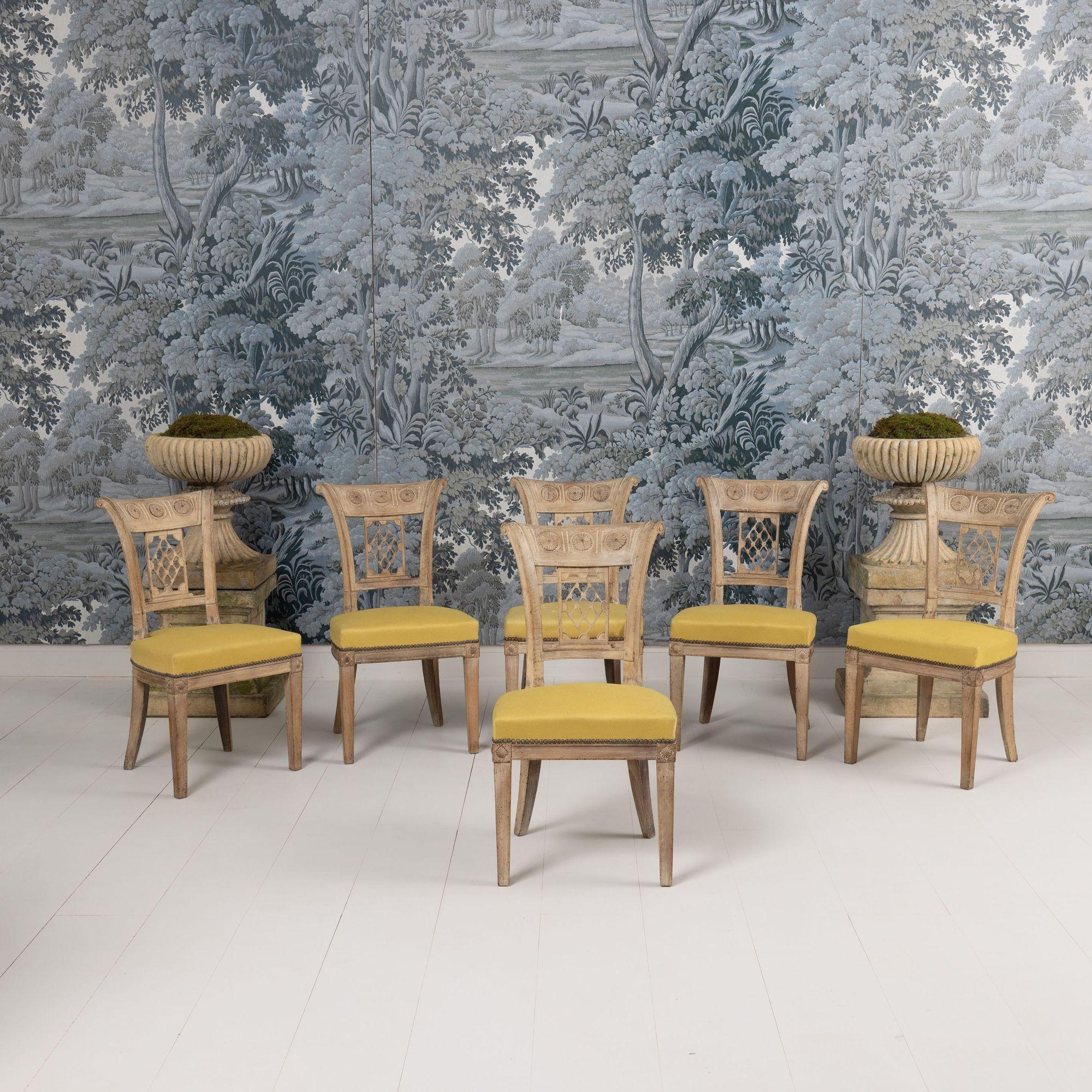 Un très charmant ensemble de six chaises de salle à manger françaises d'époque Directoire. Les cadres sont en hêtre massif blanchi et joliment patiné, avec des tenons et mortaises chevillés. Les dossiers sont de forme carrée et fuselée avec des