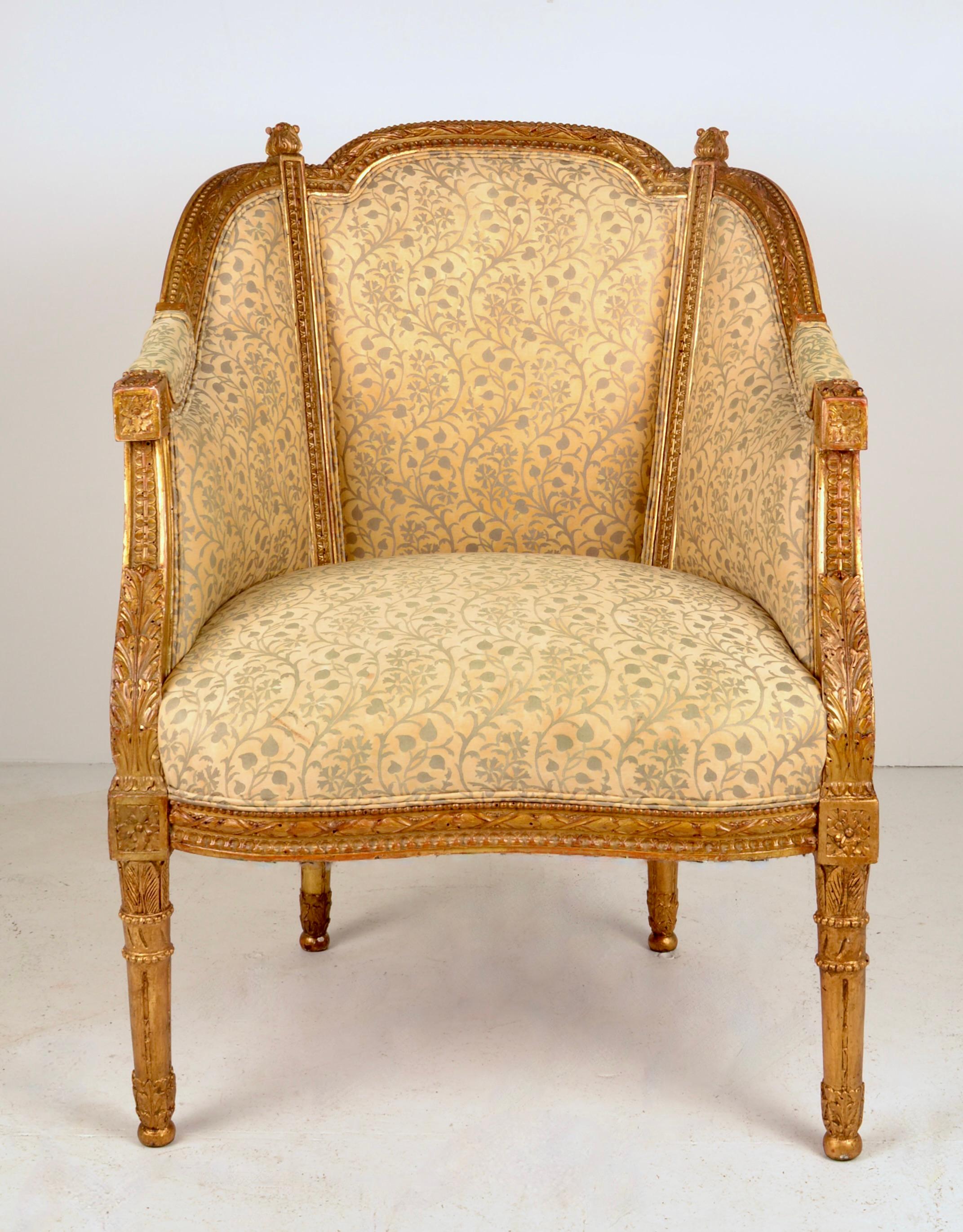A lovely example of a traditional French bergere updated with a Fortuny hand printed upholstery fabric. Original gilding on hand carved frame in very fine condition. Tight seat and fully upholstered back. 