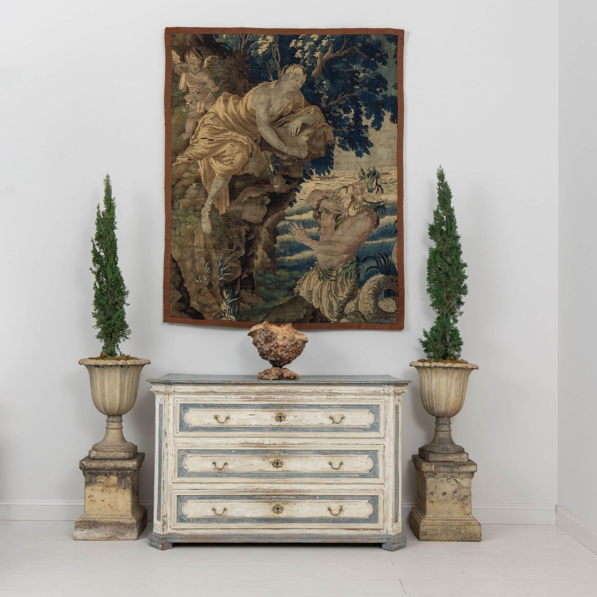 A large-scale French commode from the 18th century in the Louis Philippe style with hand-painted detail, including a hand-painted marbleized top. Shaped top and canted sides with raised panel drawer fronts. Three deep drawers that move easily.