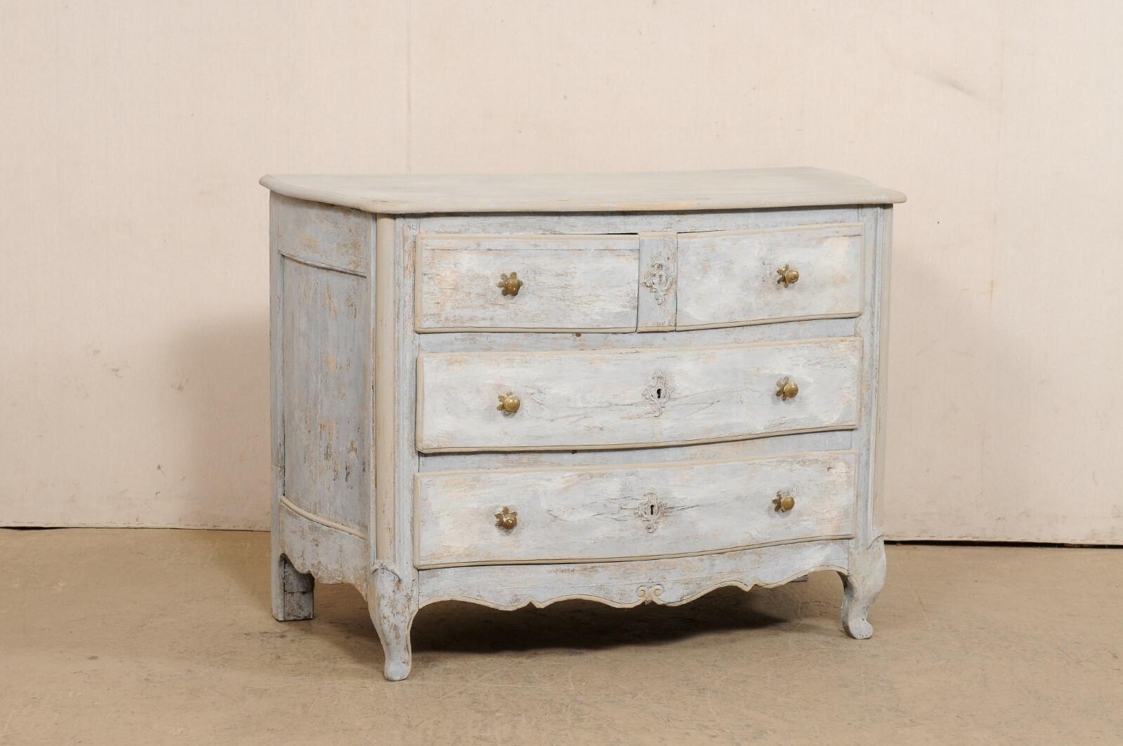 A French Louis XV carved and painted wood commode, with subtle serpentine shaped body, from the 18th century. This antique chest from France has a shapely top with serpentine front and softly outwardly scalloped sides. The body of the case carries
