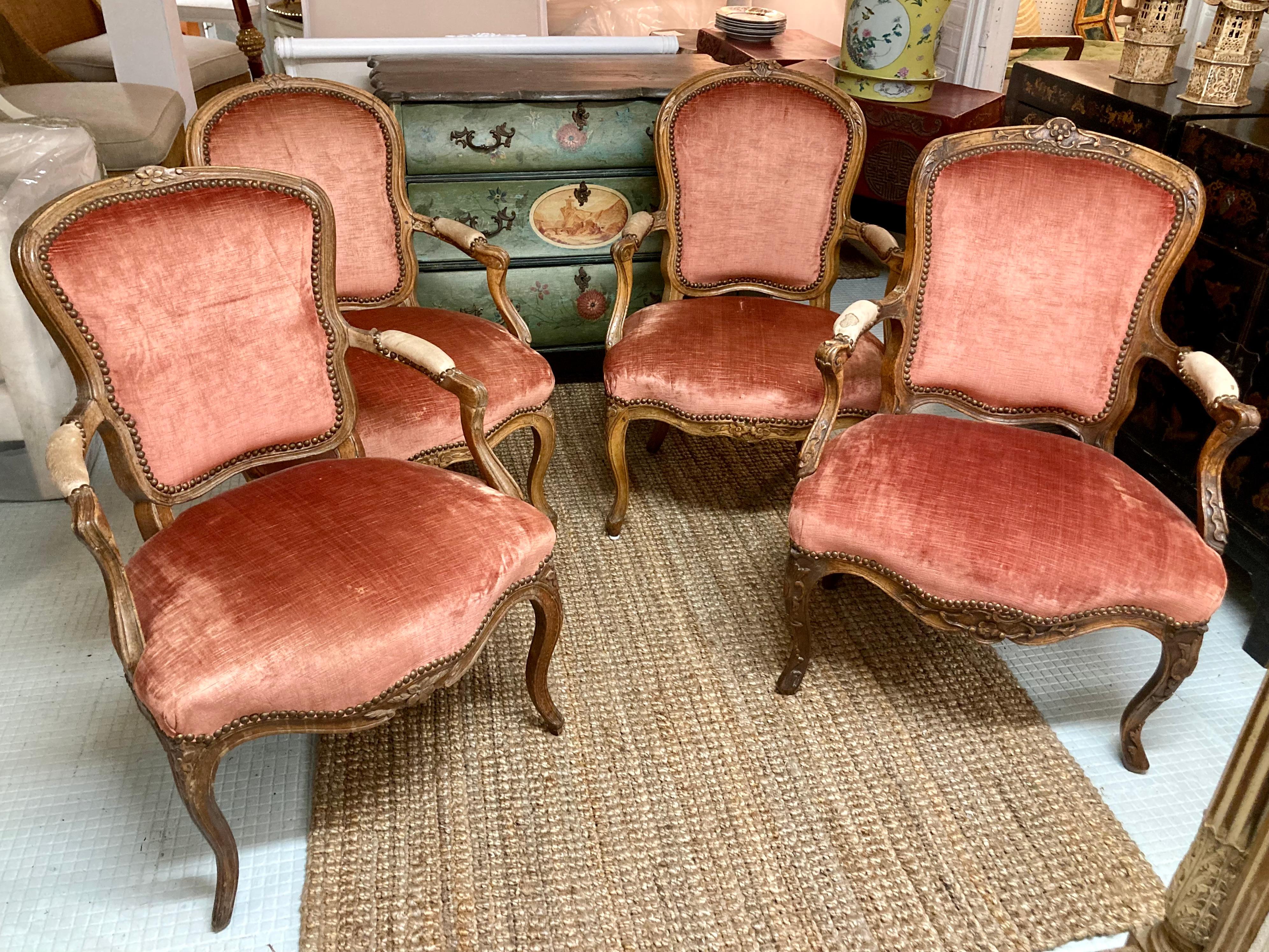 Beautiful set of 4, 18th Century French Louis XV fauteuil chairs each with unique carvings but same dimensions. Look closely at the photos showing different carving details and elements but they are all the same dimensions. Fun, beautiful grouping