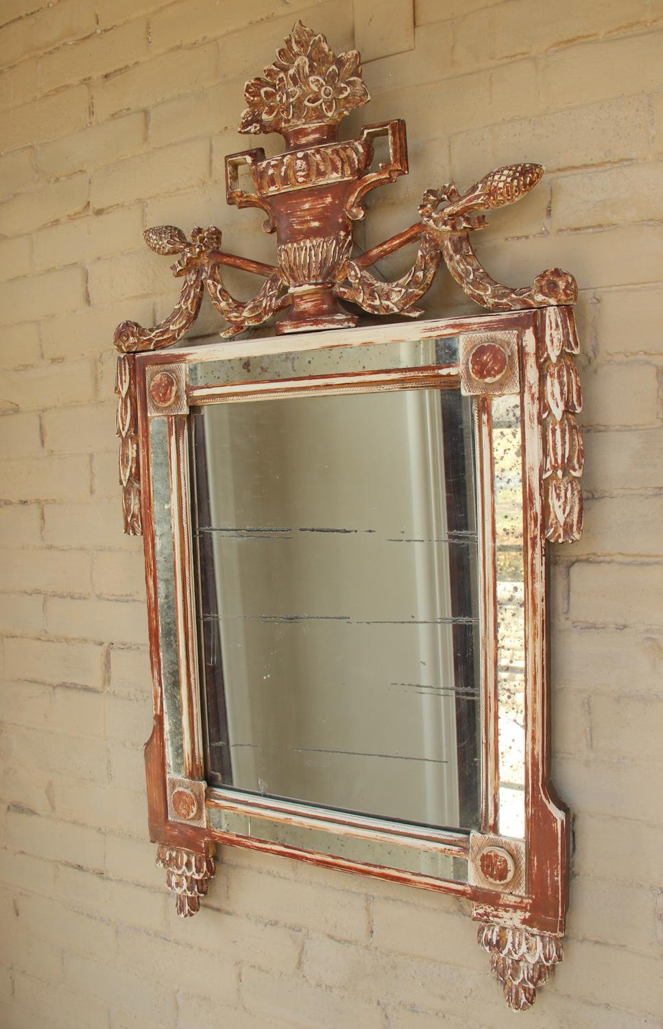 A beautiful example of French Louis XVI period mirror wearing old gesso and reddish - brown bole being base coats before gilt would have been applied. There are small traces of gilt. This stunning Louis Seize' period mirror has an urn pediment with