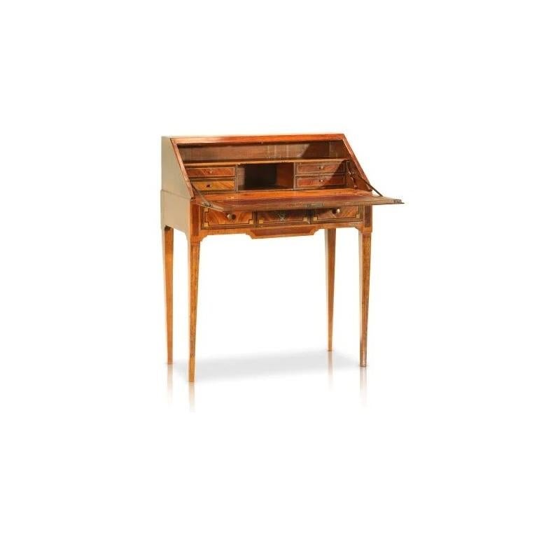 This impeccable antique French Secretaire comes with its original key and has stunning ribboned and fleur adornments with iconography typical of the Louis XVI style. Internally, a secret compartment is hidden beneath the lower cabinetry drawers and