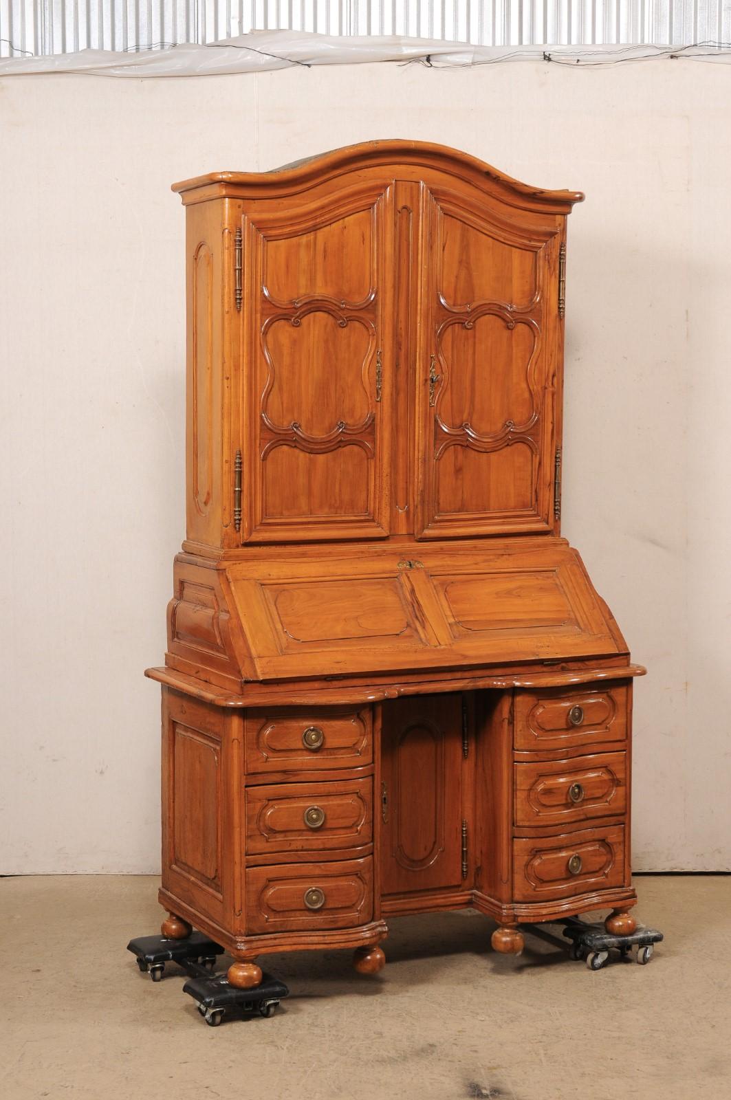 A beautiful French Louis XVI carved-cherry wood tall secretarie cabinet, with original leather on desk, from the 18th century. This antique 