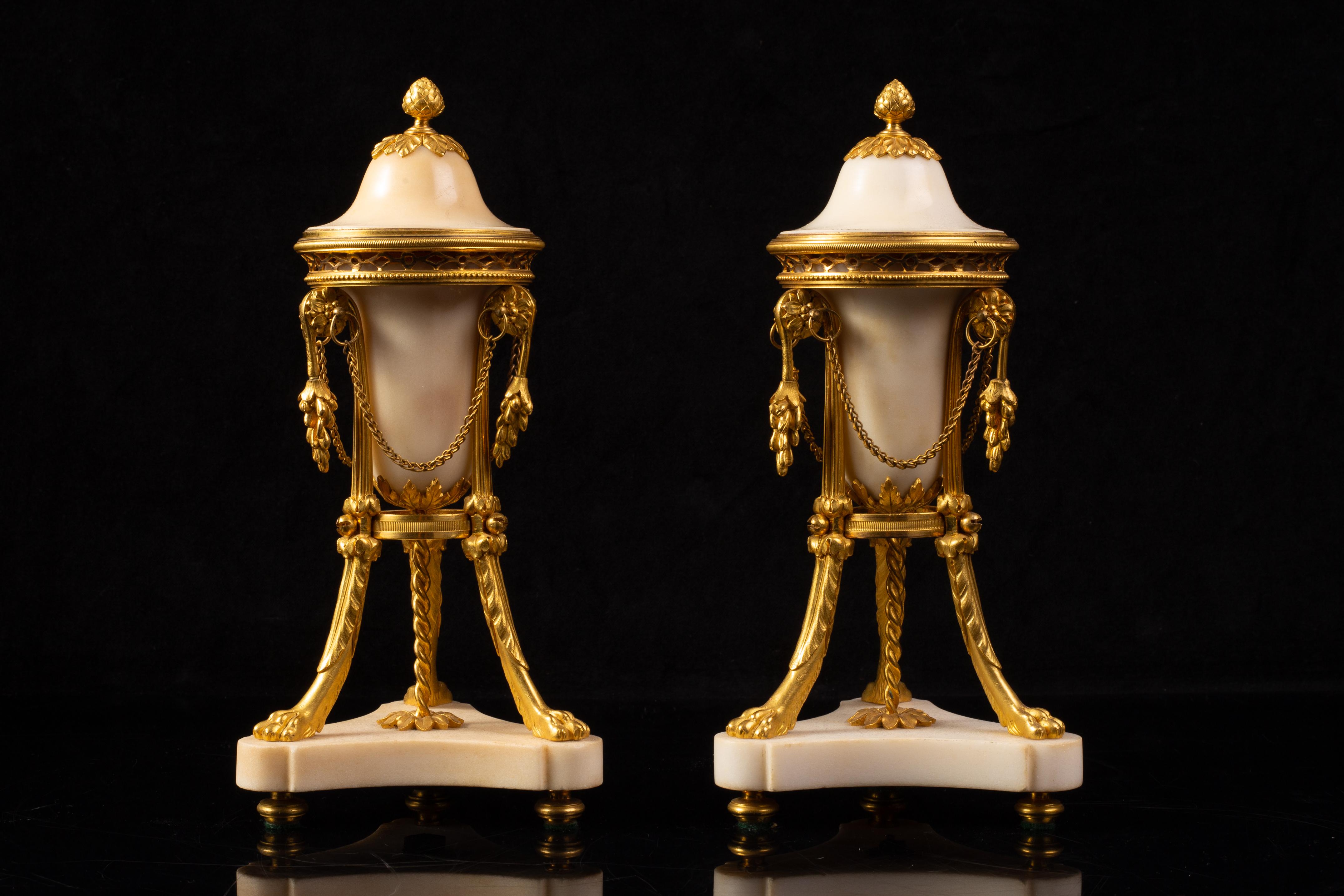Pair of 18th Century Louis XVI French Ormolu Mounted Carrara Marble Pot-Pourri Vases / Casolettes on Lion’s Paw Feet

This pair of Louis XVI casolettes is formed from smooth Carrara marble bodies set within gilt bronze tripod stands. Each vessel has