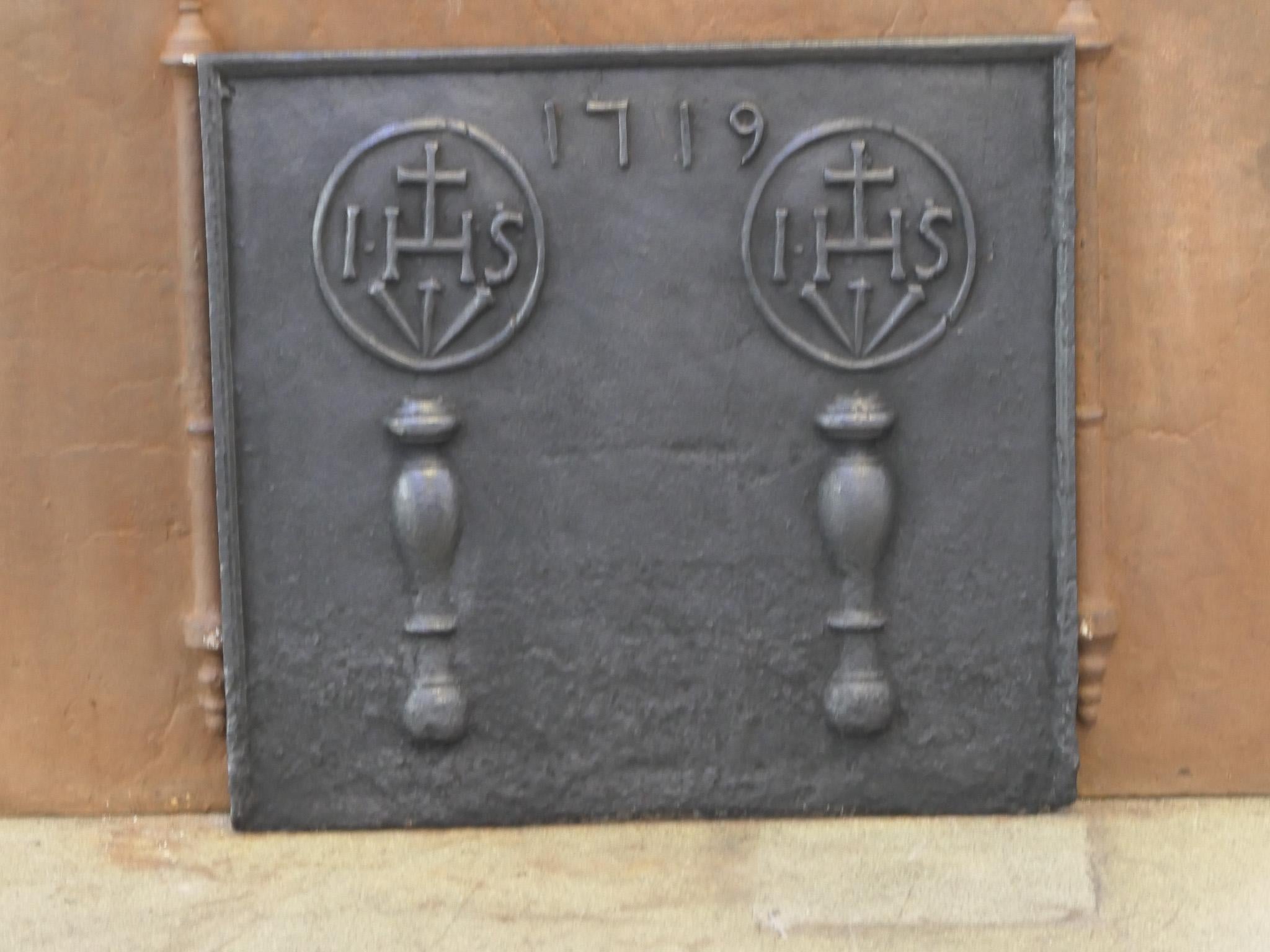 18th century Louis XIV Period French fireback with pillars, two IHS monograms, and the date of production 1719.

The monogram IHS stands for Iesus Hominum Salvator (Jesus the Savior of Humanity) or In Hoc Signo (In this sign will you win). The