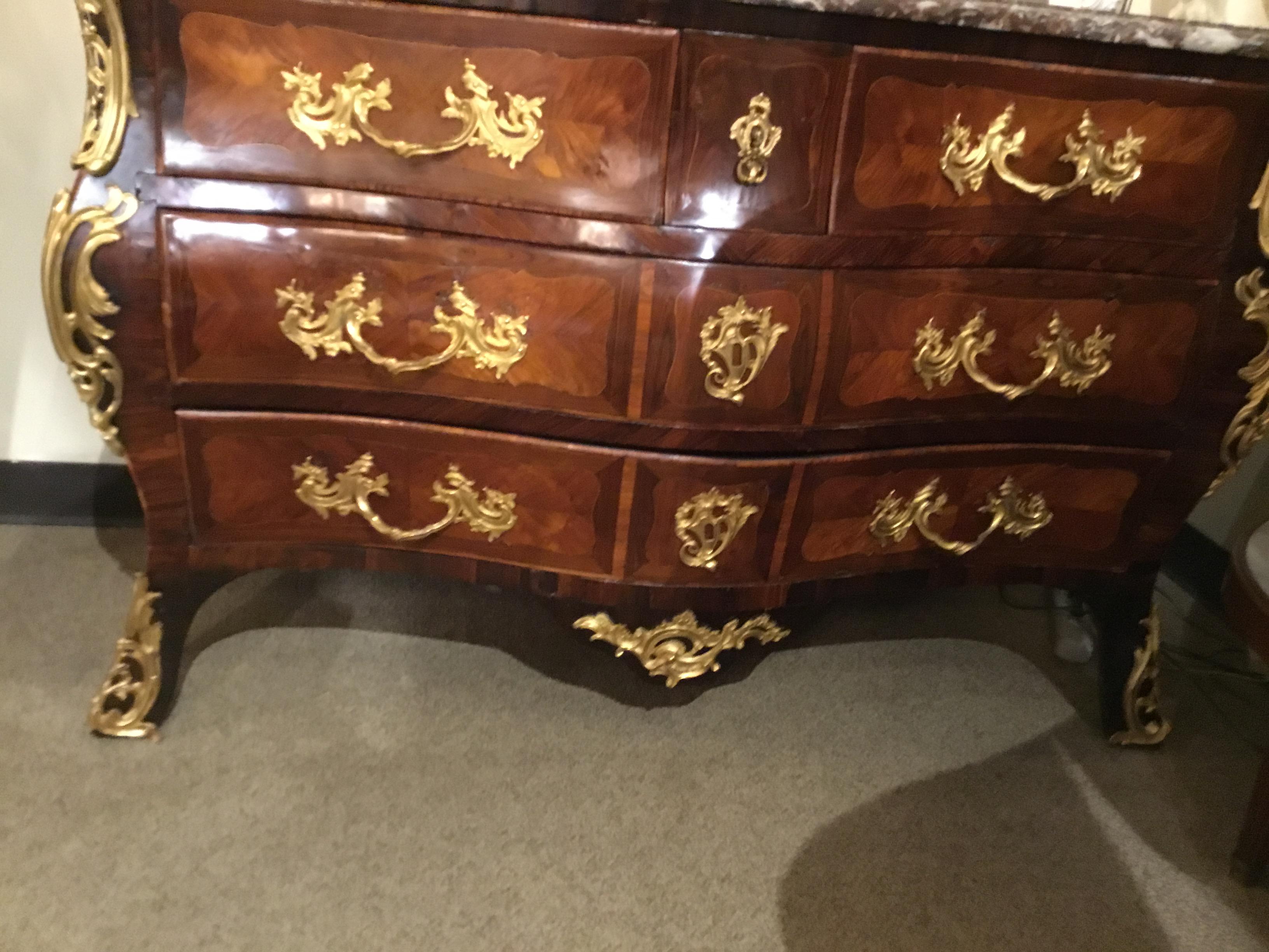 This French 18th century commode is in the regence style. Bronze
Handles in a brilliant hue and Fine and quality construction throughout this piece make it exceptional. The construction and fine aged patina show its quality.
It is made of the finest