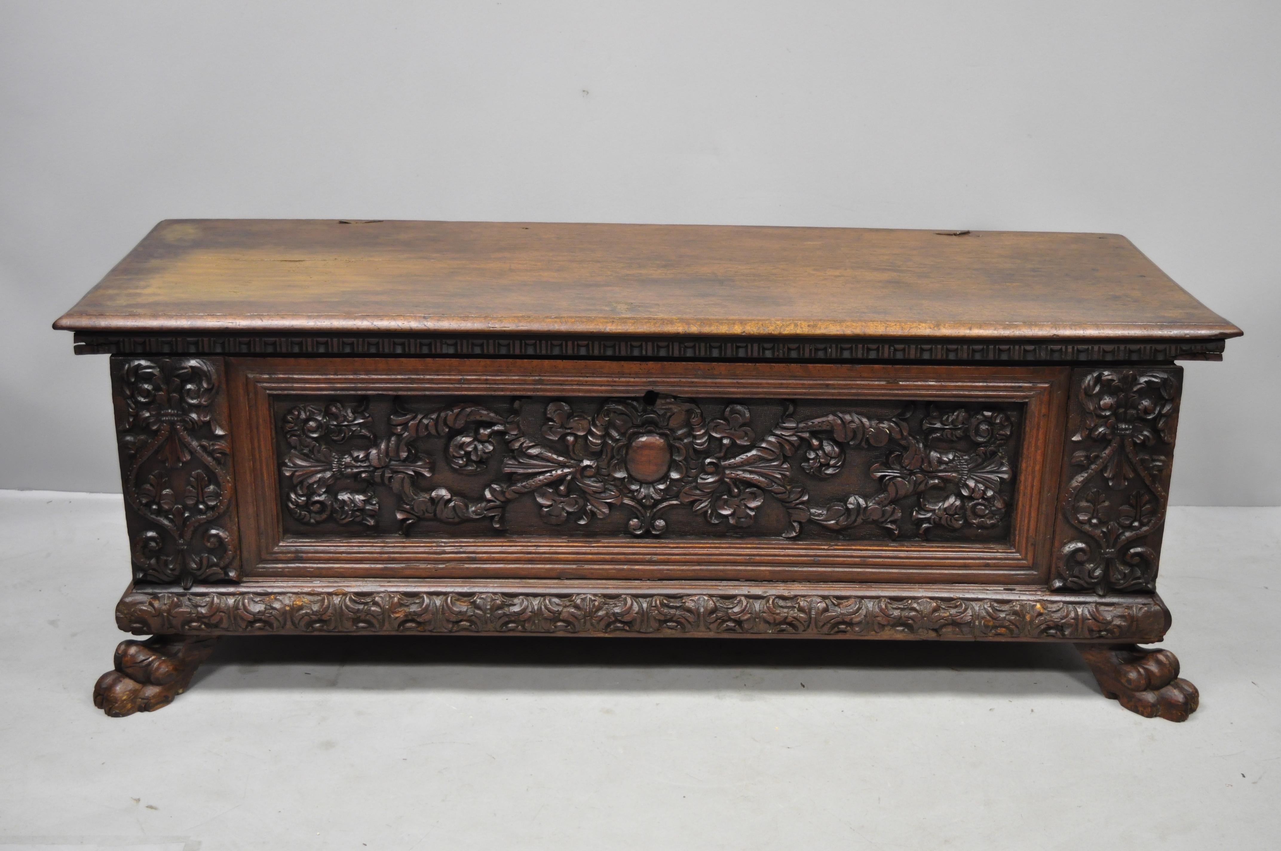 18th century French Renaissance carved walnut paw foot coffer trunk blanket chest. Item features ornate carved flowers and scrollwork, solid wood construction, beautiful wood grain, no key, but unlocked, carved paw feet, very nice antique item,