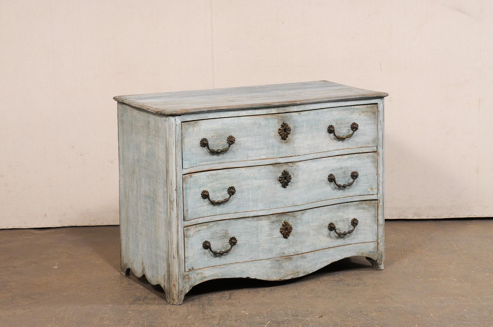 A French painted and carved wood serpentine chest from the 18th century. This antique commode from France features a slightly overhanging top, with rounded front corners, and curved along the front edge in which to mimic the beautiful lines of the