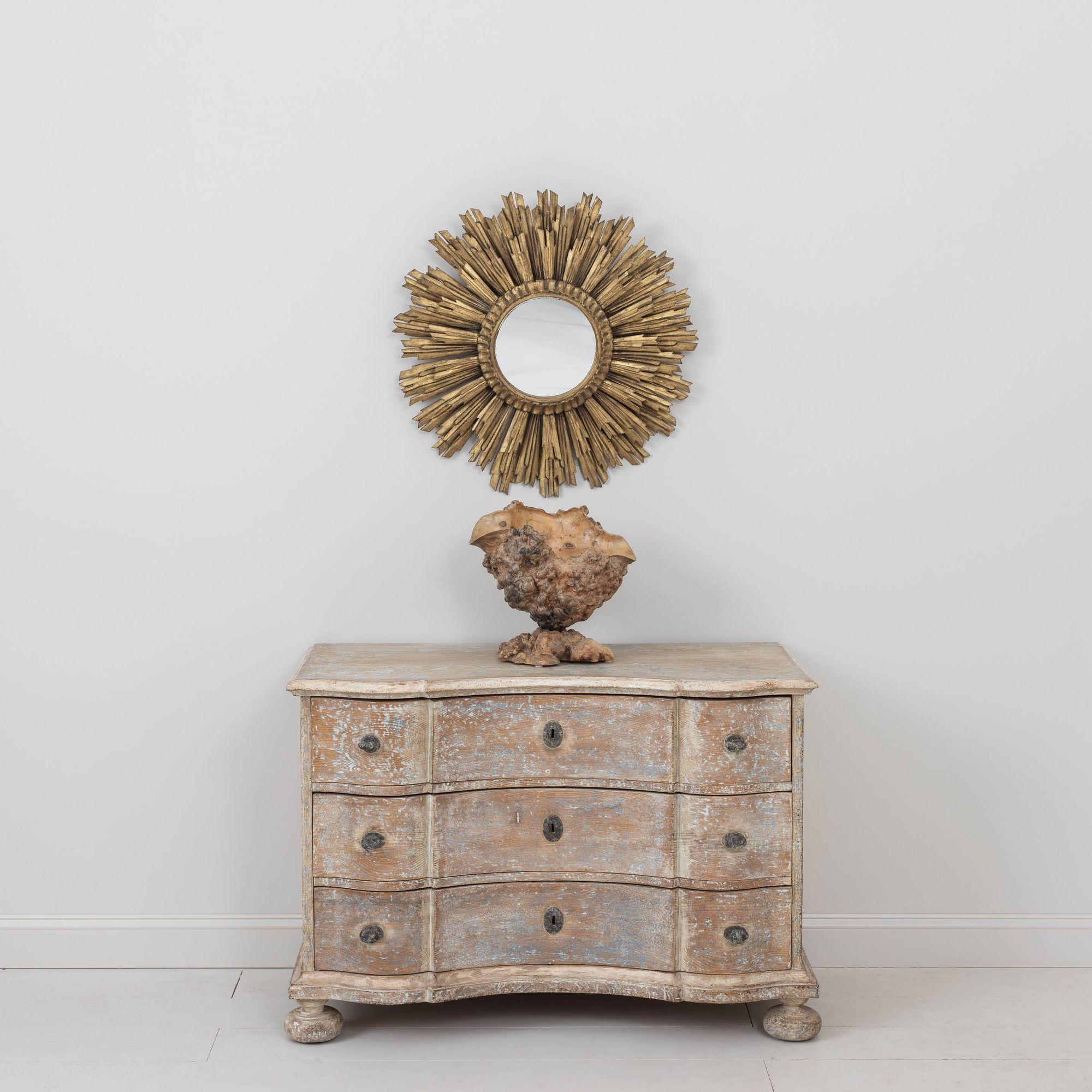 A German chest of drawers from the 18th century in original, natural pine with traces of original paint. Shaped top and beautifully carved arbalette shaped drawers with original hardware, standing on bun feet. Found in Provence, France.