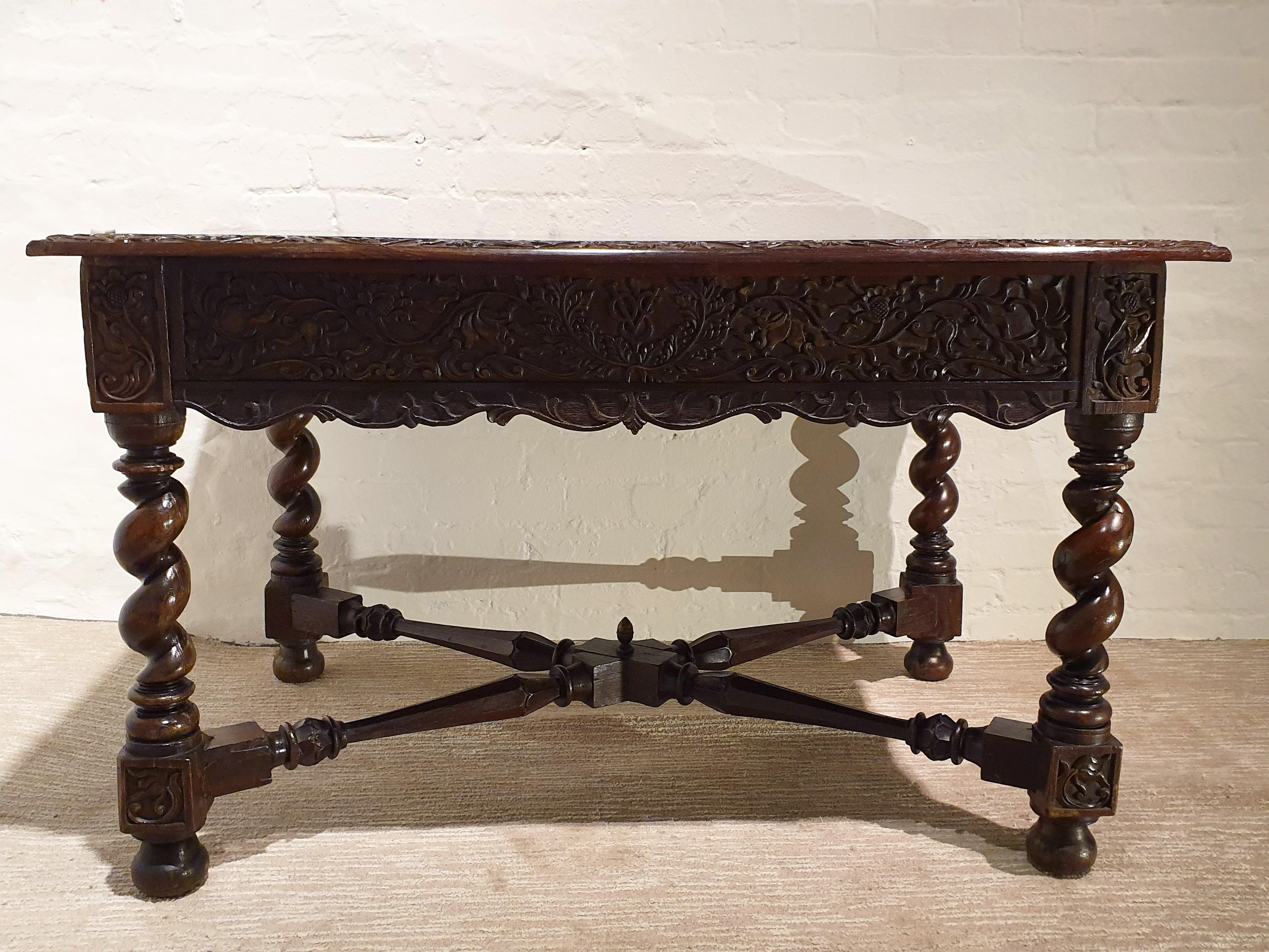 This beautiful and truly stunning 18th century rosewood table features an intricately and detailed hand-carved design of scrolls and vines around the sides and top edges of the piece, with an inset hardwood burr top. It was done for the Dutch East