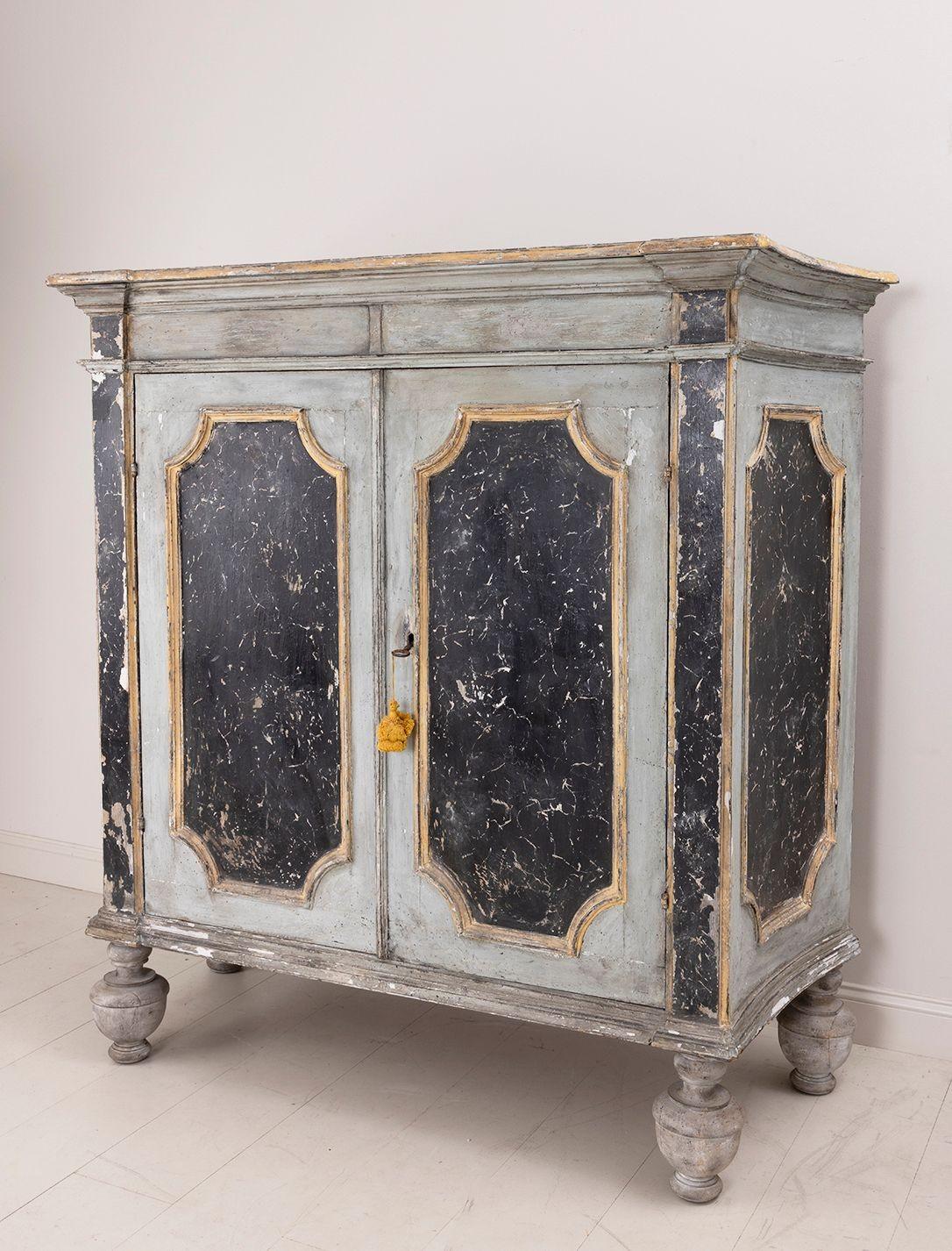 A late 18th century Italian armoire cabinet in the Baroque style with handsome, elongated bun feet. Inside the cabinet there is one fixed shelf. The lock is original. This is a beautiful, original piece with plenty of storage potential that will