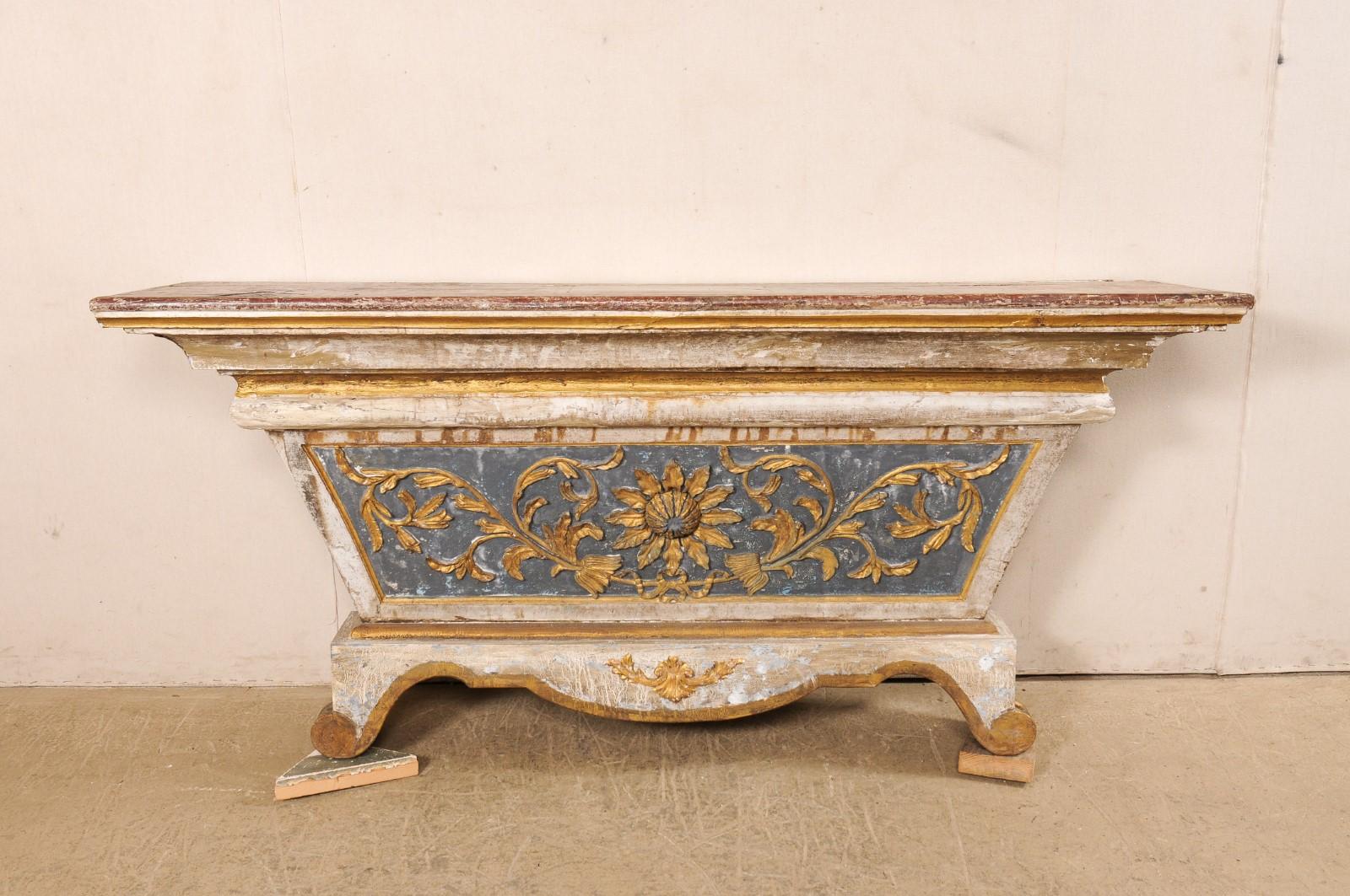 An Italian carved and painted altar from the 18th century, which we envision making a fabulous wall-mounted console table! This antique table from Italy, once used as an alter, has a trapezoidal shape with good-sized top that spans just over six
