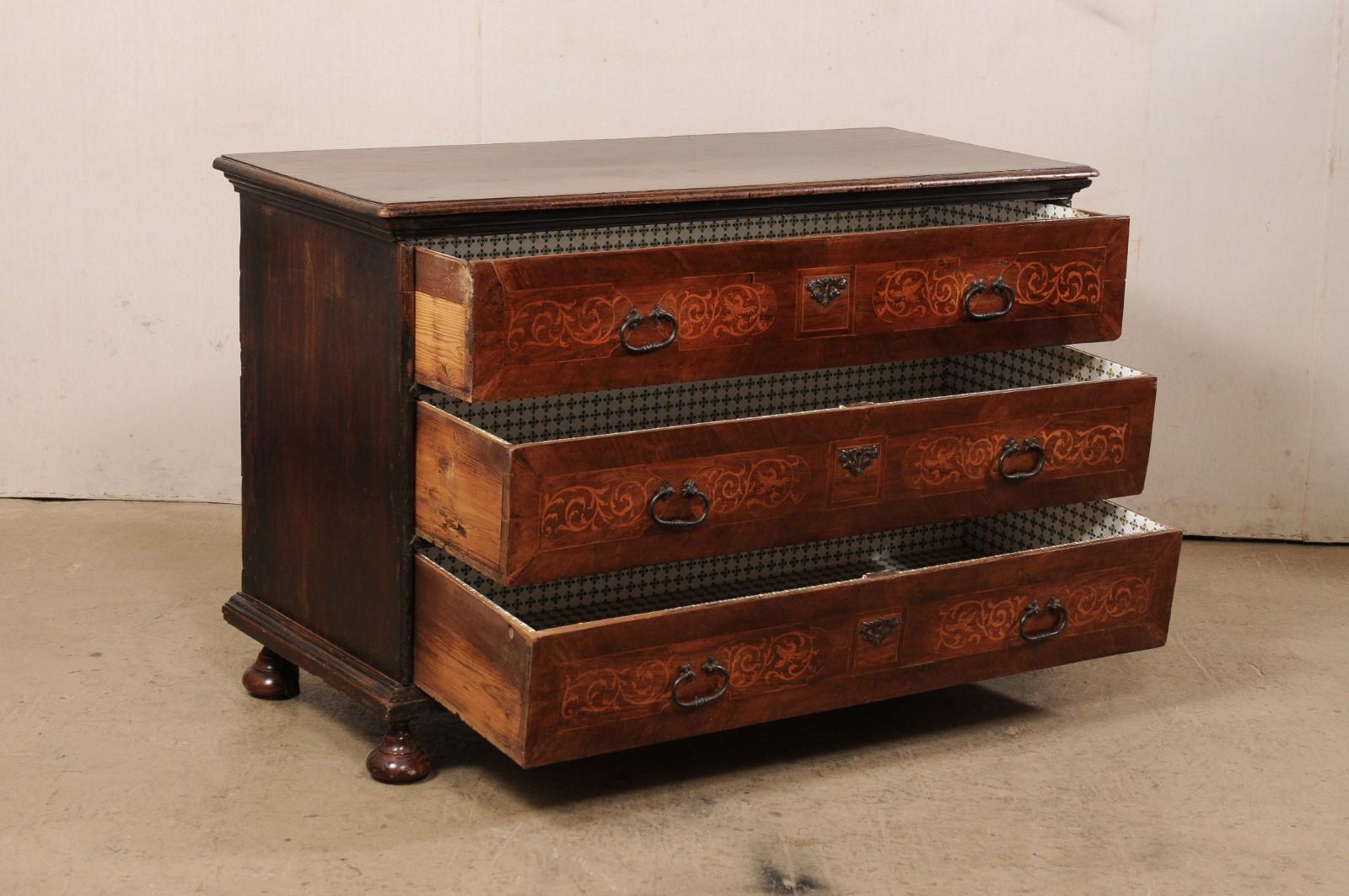 An Italian wooden chest of three drawers from the mid-18th century. This antique chest from Italy has a rectangular-shaped top with molded edging that slightly overhangs the case below, which houses three full-sized drawers. Each drawer front is