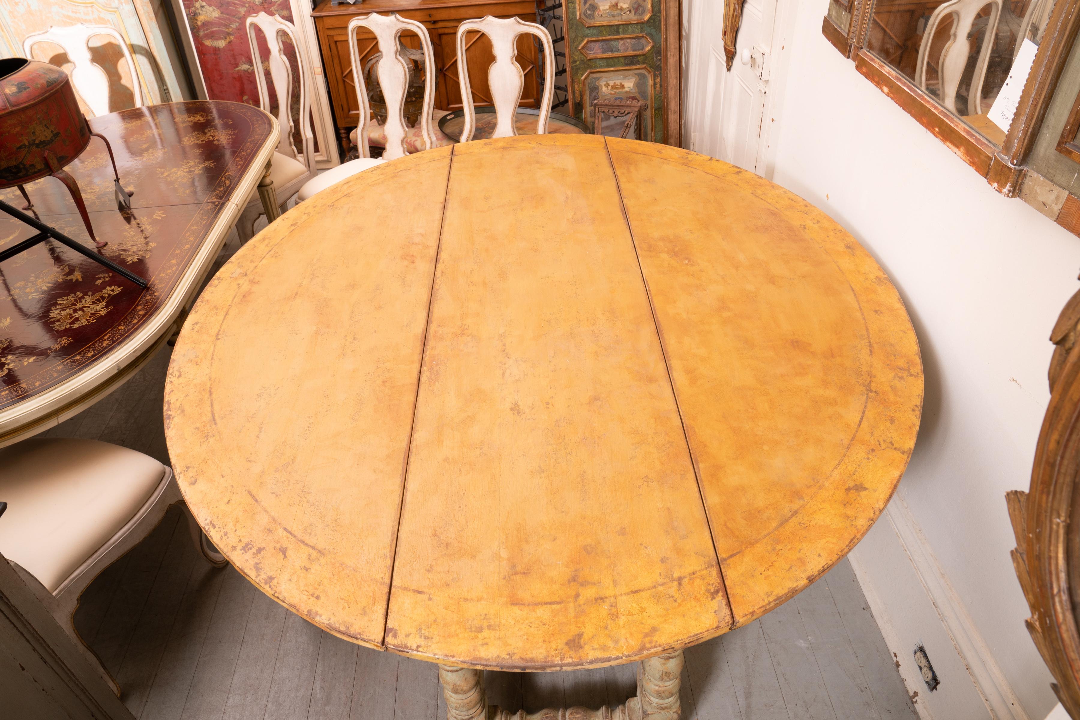 Italian country Gateleg harvest table with leather surface. Beautiful patina and structurally sound table with a fantastic structure. The carved legs support a wonderfully worn and patinated leather work surface. The versatility of this table and