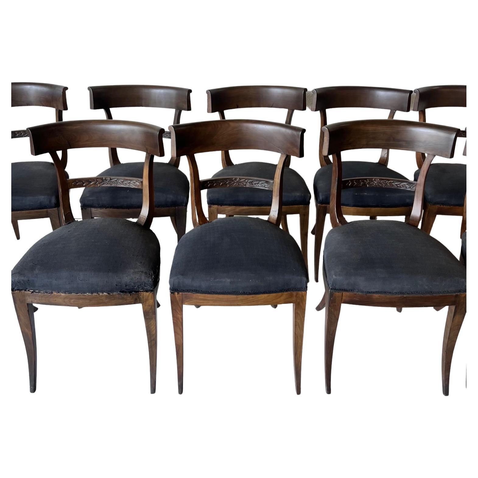 18th C Italian Klismos Chairs set of 10. Concave backrest with curved legs (Klismos). The Klismos style is timeless and classic and never goes out of style. The upholstery on the chairs is very distressed. Purchased In Lucca Italy from 1750's.