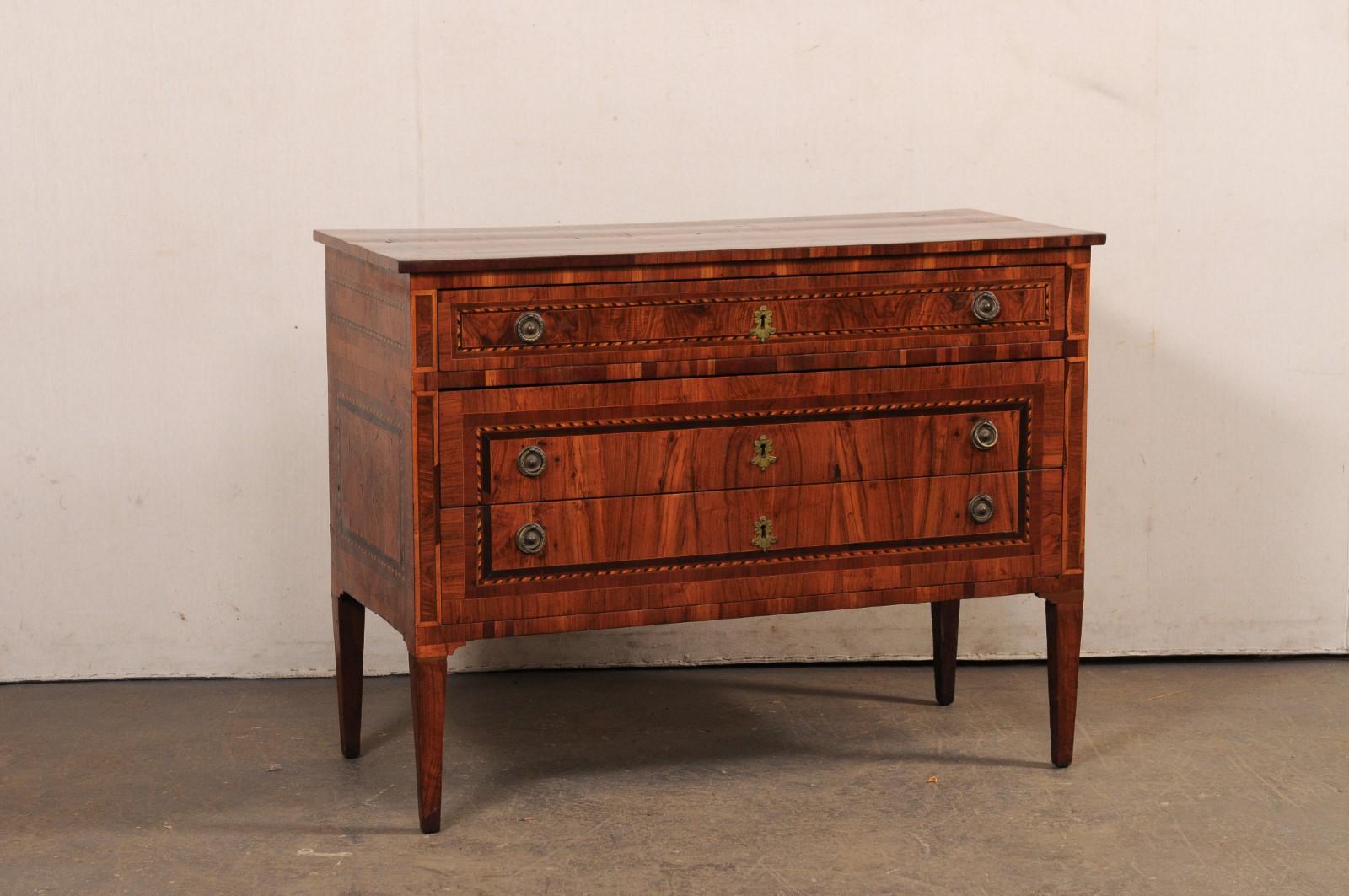 A period Neoclassical Italian three-drawer raised side chest, with veneered wood and decorative inlay banding, from the 18th century. This antique side chest from Italy has been designed in nice, clean/linear lines, allowing the beautifully veneered