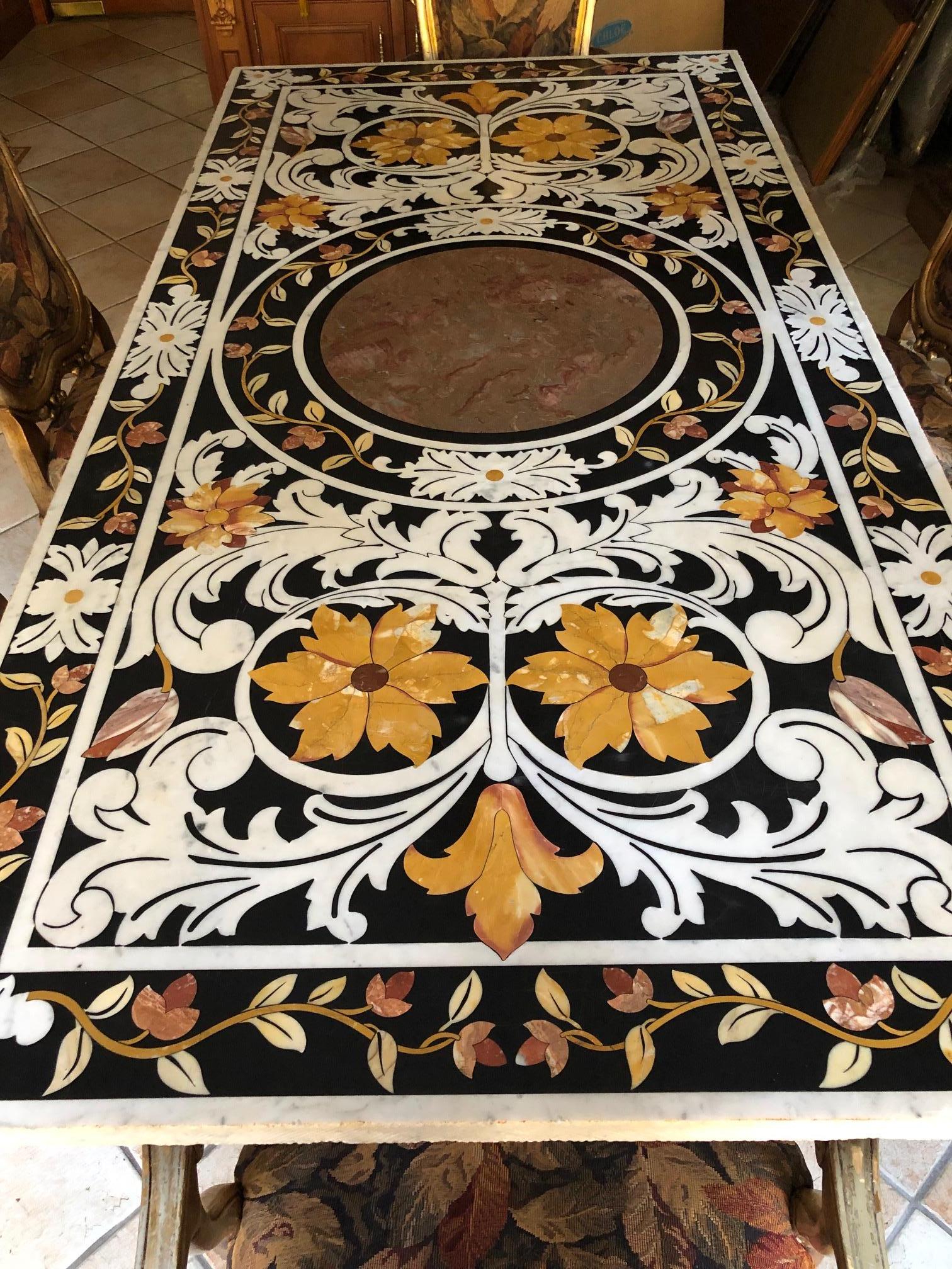 Rare 18th century Italian white marble Pietra Dura and scagliola marquetry stone inlaid top dining table with colorful floral vine decoration on black and white ground, set on carved stone figural bases 79