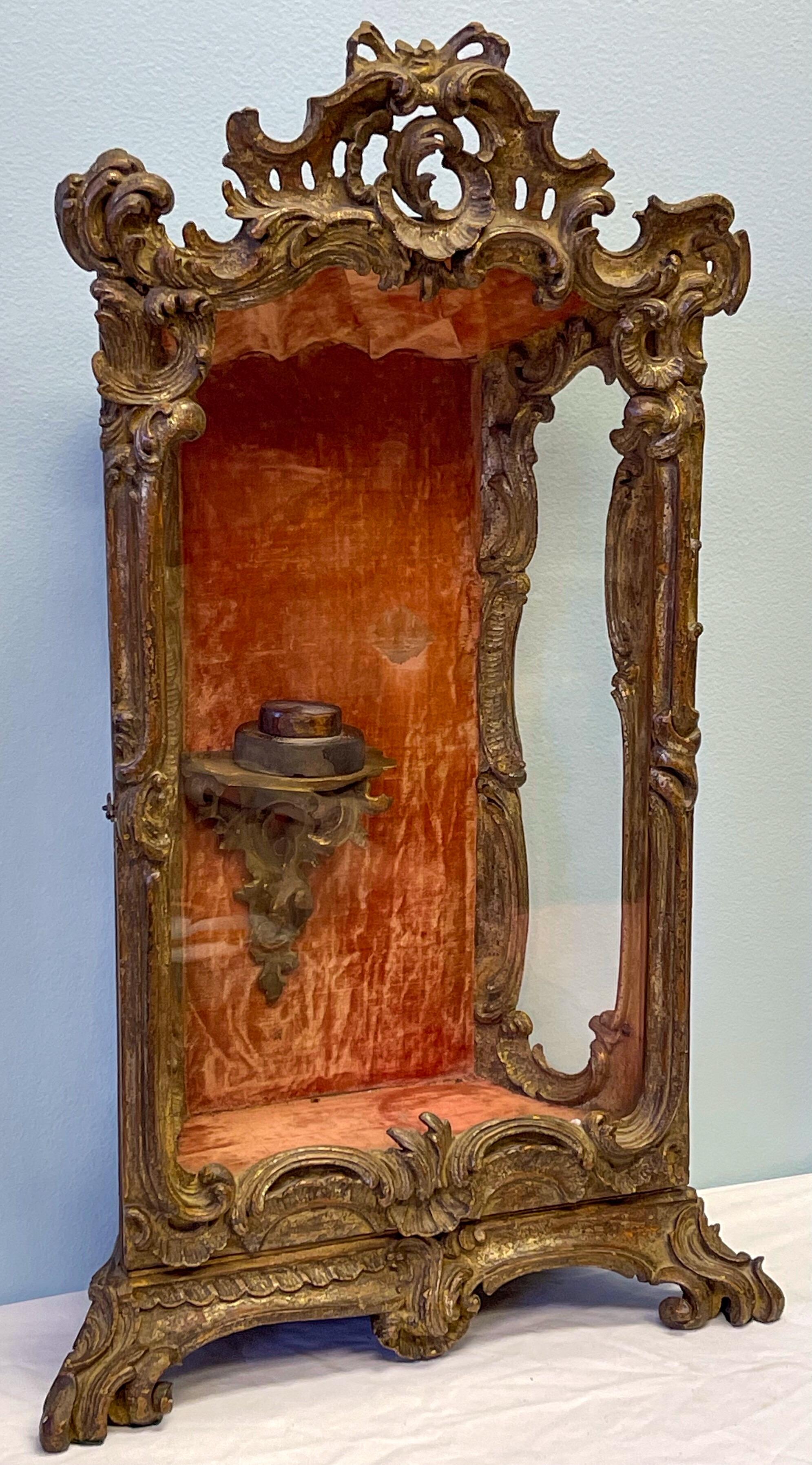 Most favorite Piece! This is a 18th century Italian Rococo carved giltwood table top vitrine or reliquary. It opens to a velvet lined walls and a tiny Rococo wall bracket. It can be hung on the wall. These were often used for religious figures.