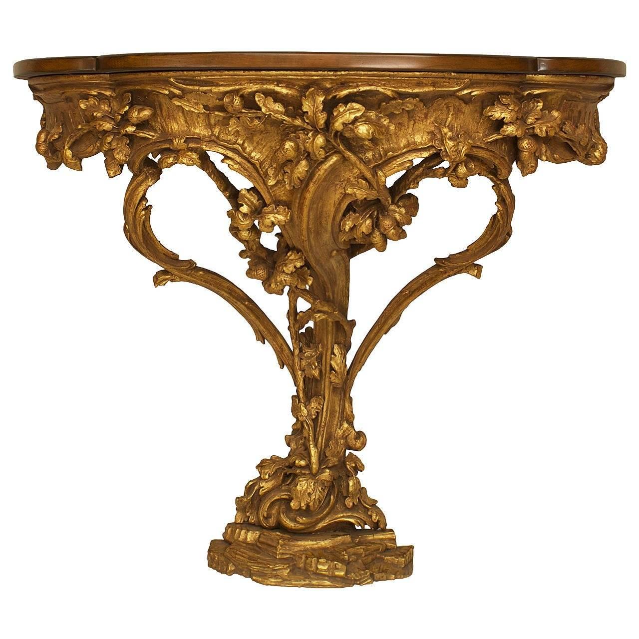 Italian Rococo (circa 1770) gilt wood console table with a floral filigree design and shaped top.
