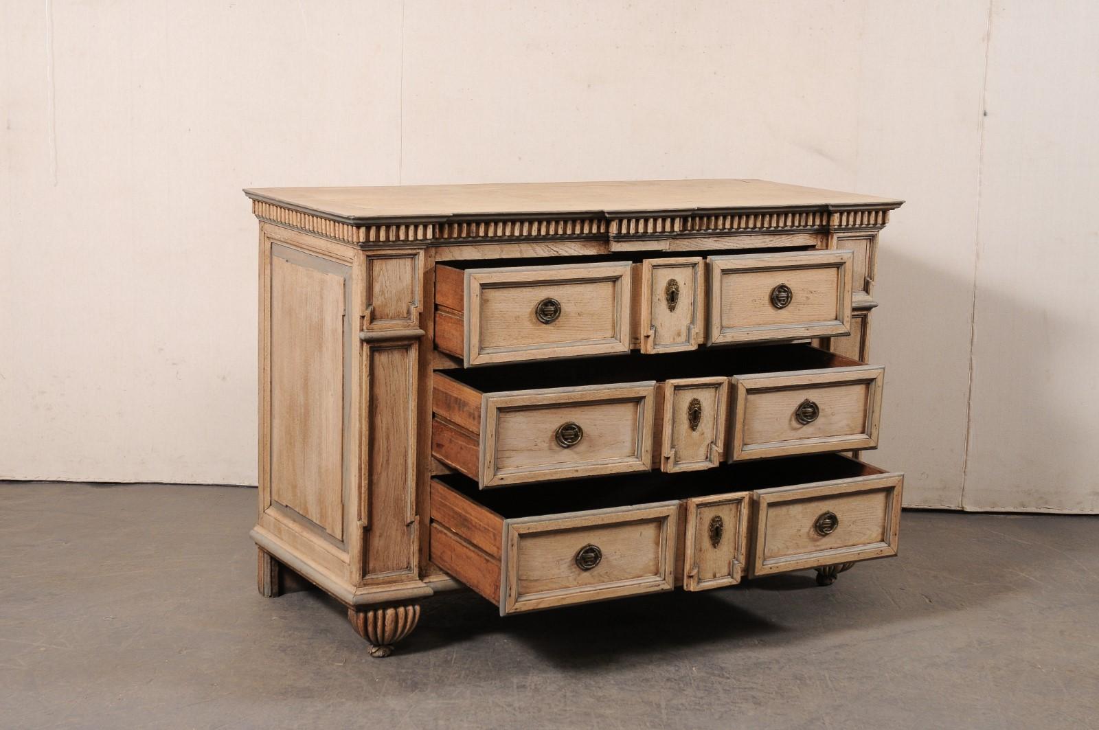 A fabulous Italian Tuscan carved-wood chest of drawers from the 18th century. This antique chest from Tuscany, Italy features a subtle break-front design along its front, with a nice dentil molding accentuating the underside of the top on three