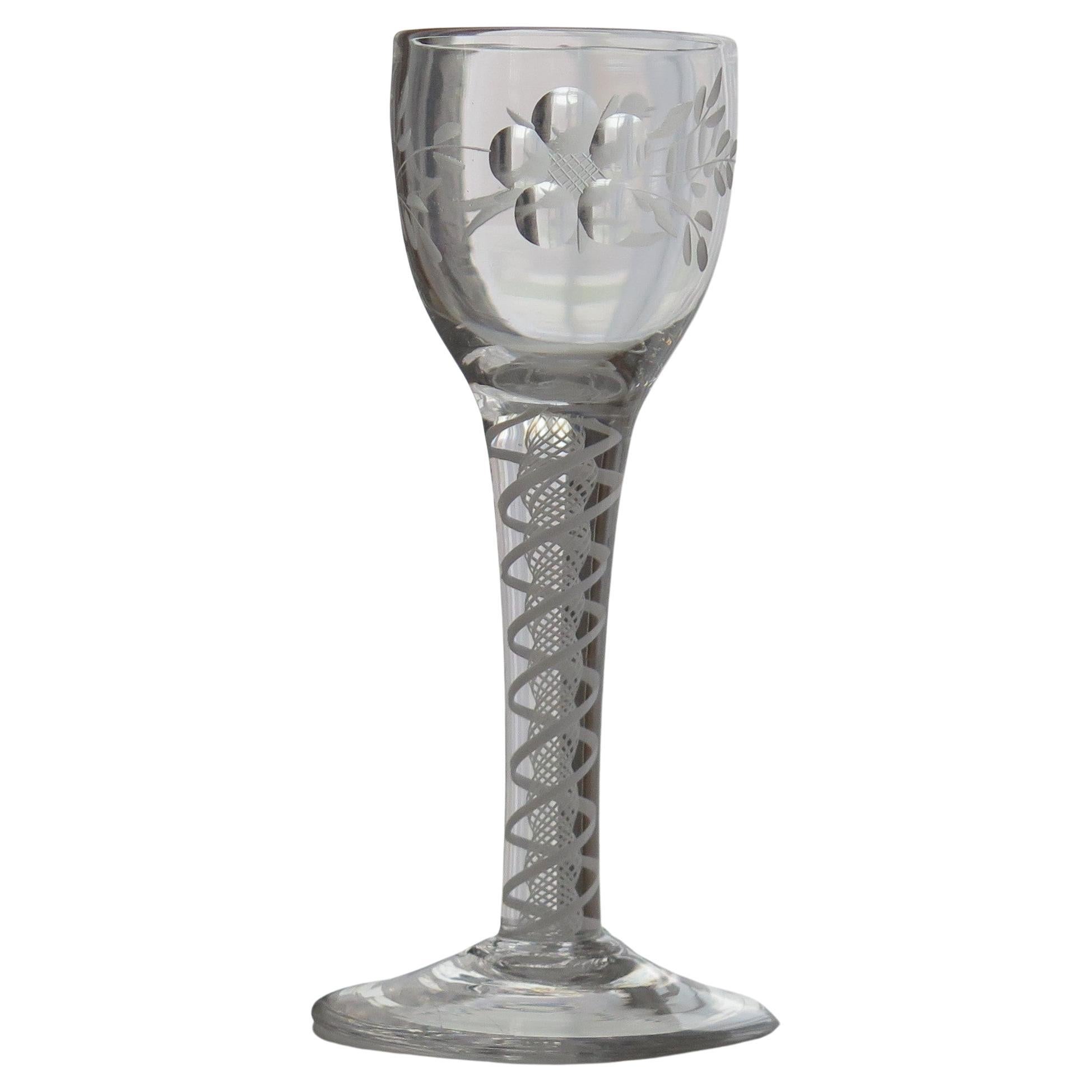 This is a very good hand-blown, Jacobite English, mid-Georgian, wine drinking glass with an engraved bowl and an opaque twist stem, dating from the middle of the 18th century, circa 1760.

Jacobite glasses have historical significance and are very