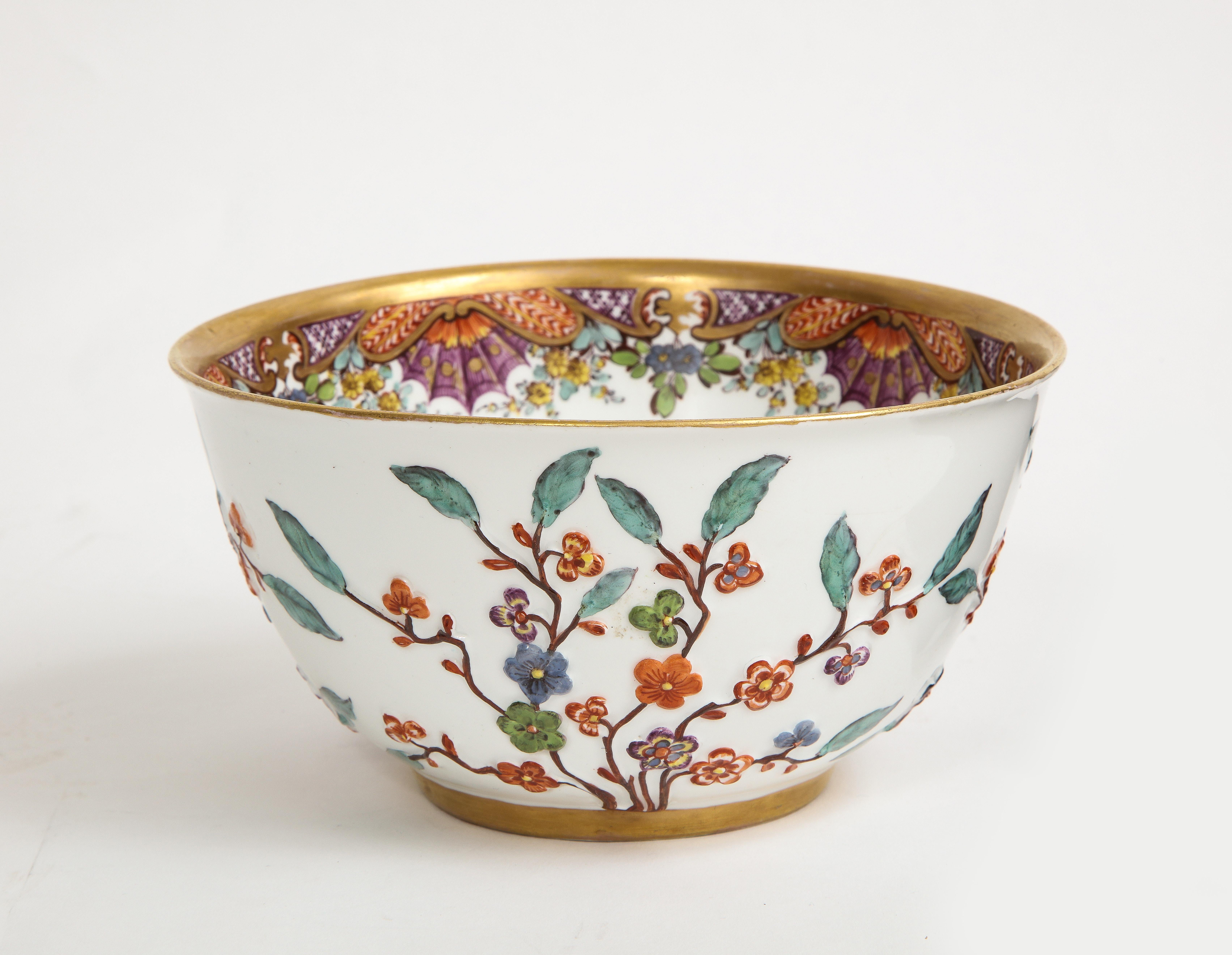 An Incredible and Rare 18th Century Meissen Hausmaler Decorated Bowl with High Relief Multi-Colored Flowers.  Hand-carved with encrusted and relief flowers which decorate the exterior wall of the bowl.  The bowl is decorated with Hausmaler designs,