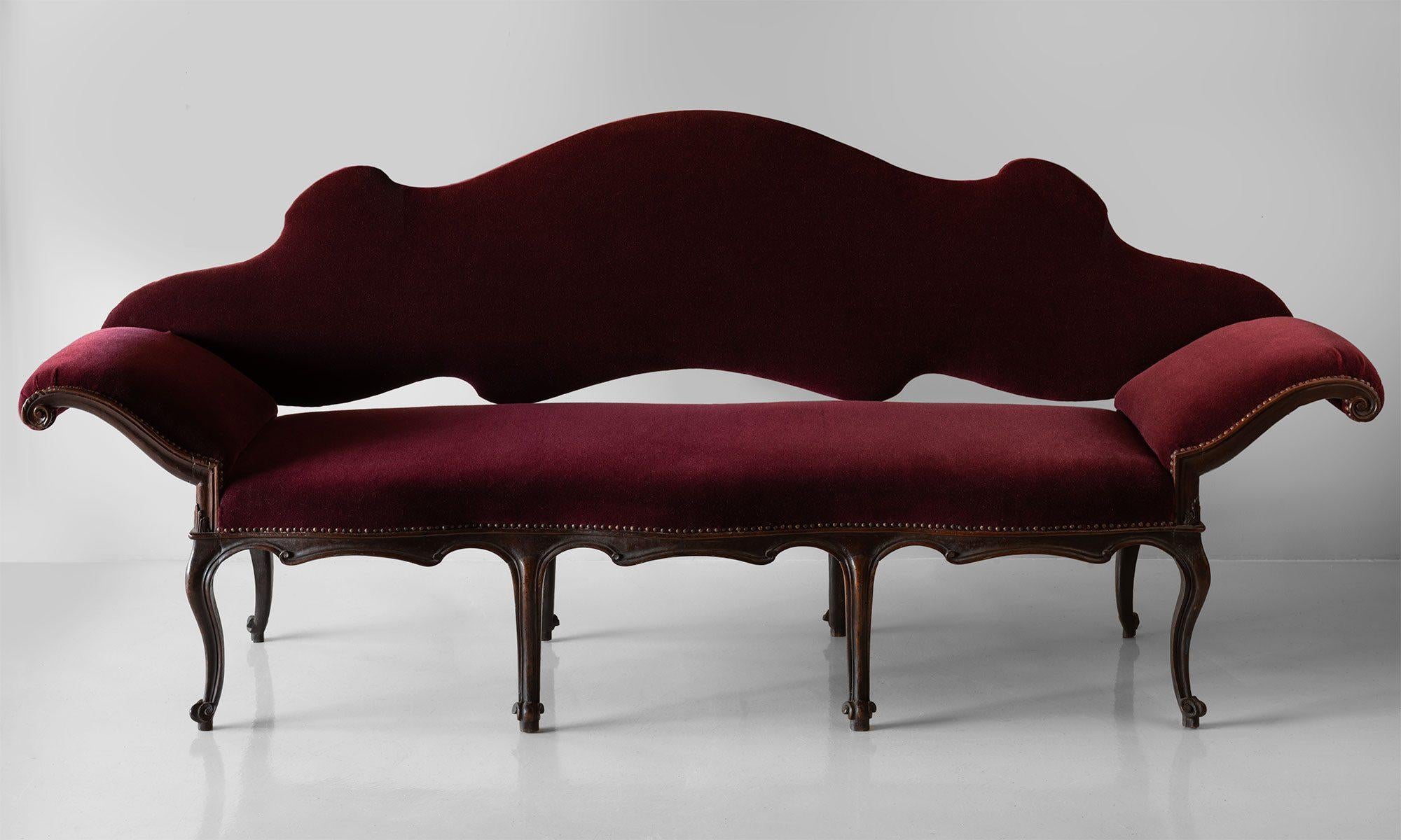 18th century Mohair and walnut sofa, Italy, circa 1790.

Newly upholstered in mohair with wonderful form and original wood frame. This piece can convert into a daybed by removing the backrest.