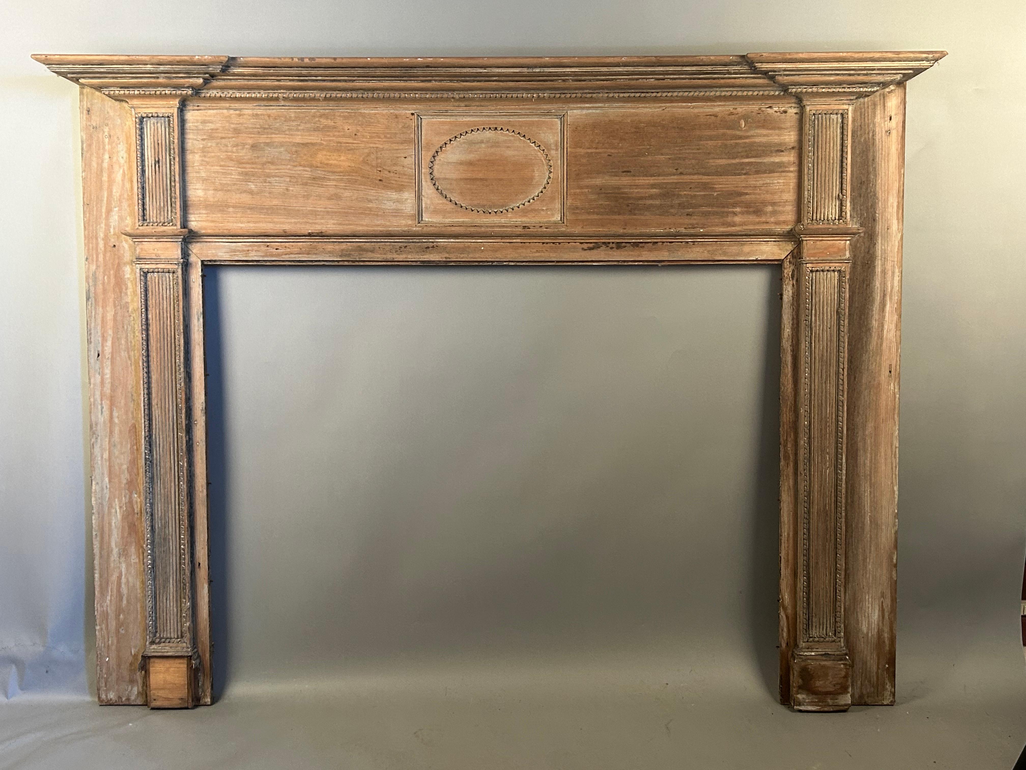 Antique fireplace mantels are the focal point and centerpiece for any room. Made circa 1790-1800, this mantel has an unusual oval medallion with saw tooth design and rope twist highlights. This piece has been carefully stripped down to a beautiful