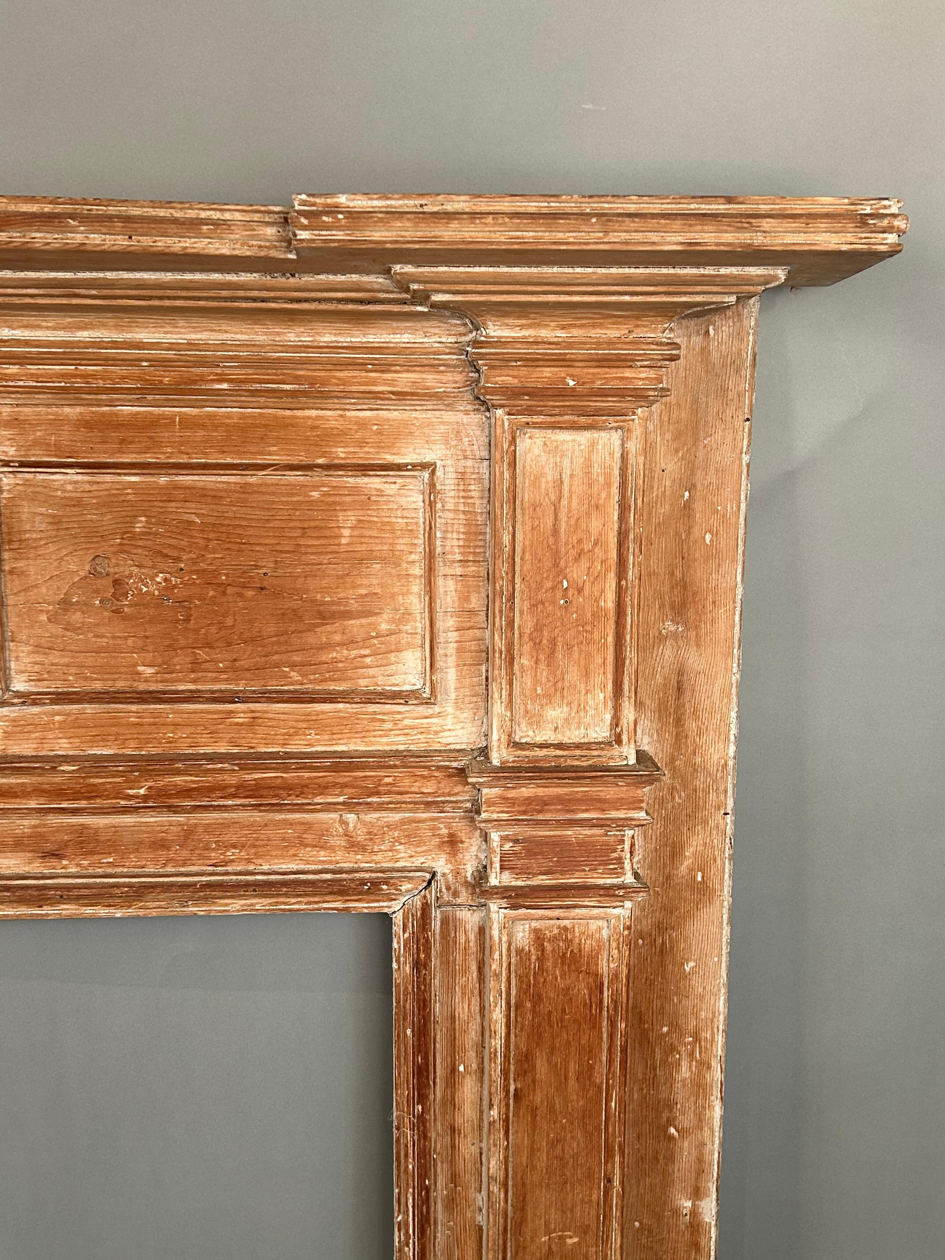 Antique fireplace mantels are the focal point and centerpiece for any room. Made circa 1790-1800, it has a nicely shaped shelf and paneled field and well formed moldings. This piece has been carefully stripped down to a beautiful wood toned surface.