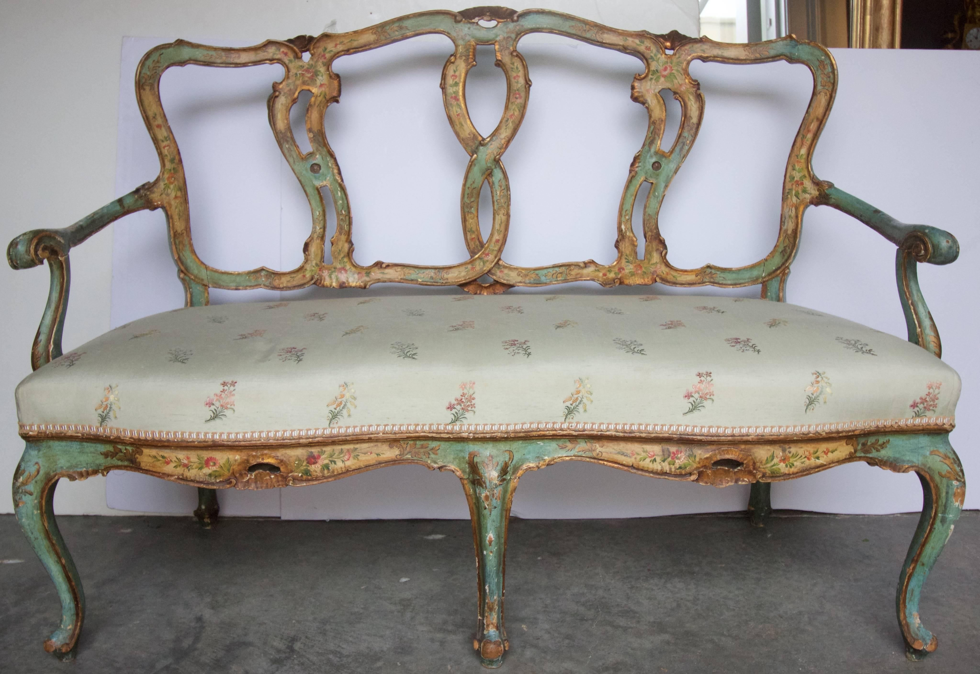 Hand-painted and carved Venetian Canape'. Exquisite in design and execution in a deep robin’s egg blue with cream and gold and hand-painted flowers and details. Nice Patina. Cabriole Legs, Serpentine seat rail.
Light and elegant in nature.