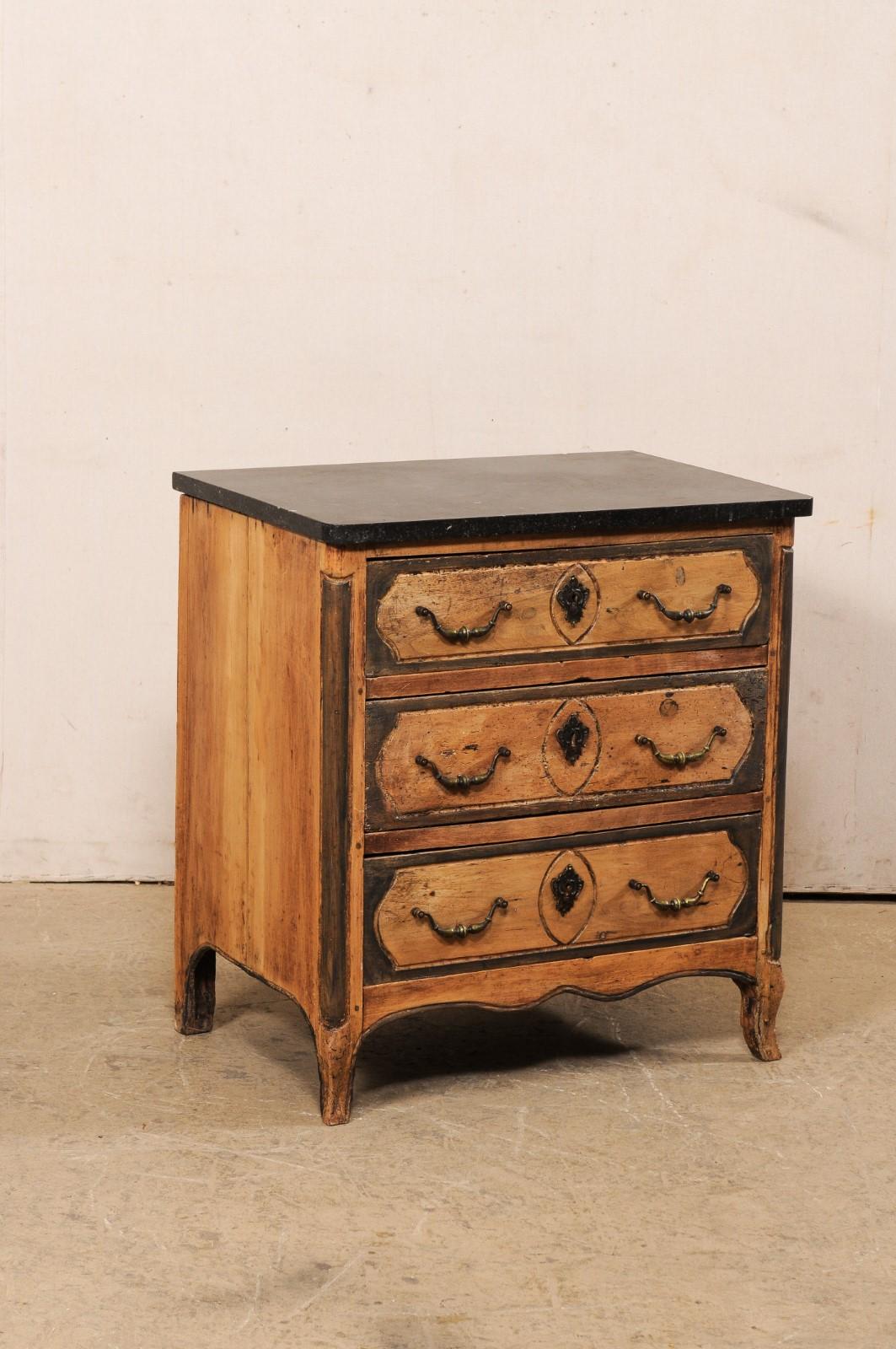 A French petite-sized chest with its original marble top from the 18th century. This antique commode from France retains its original marble top which rests atop the carved-wood case with rounded front side posts that flank three graduated drawers,